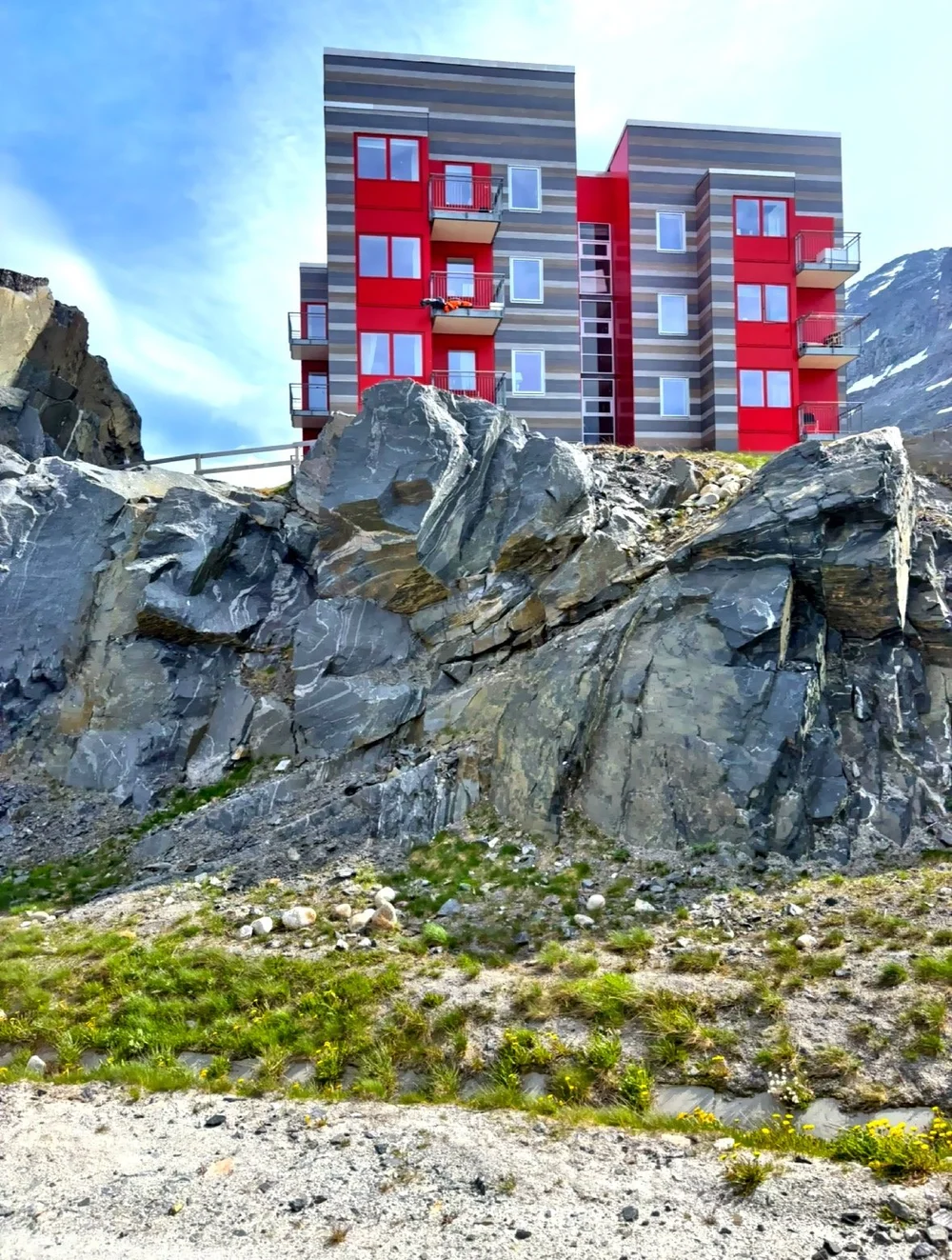  Nestled between mountains and fjords, colorful buildings dot the rocky landscape. 