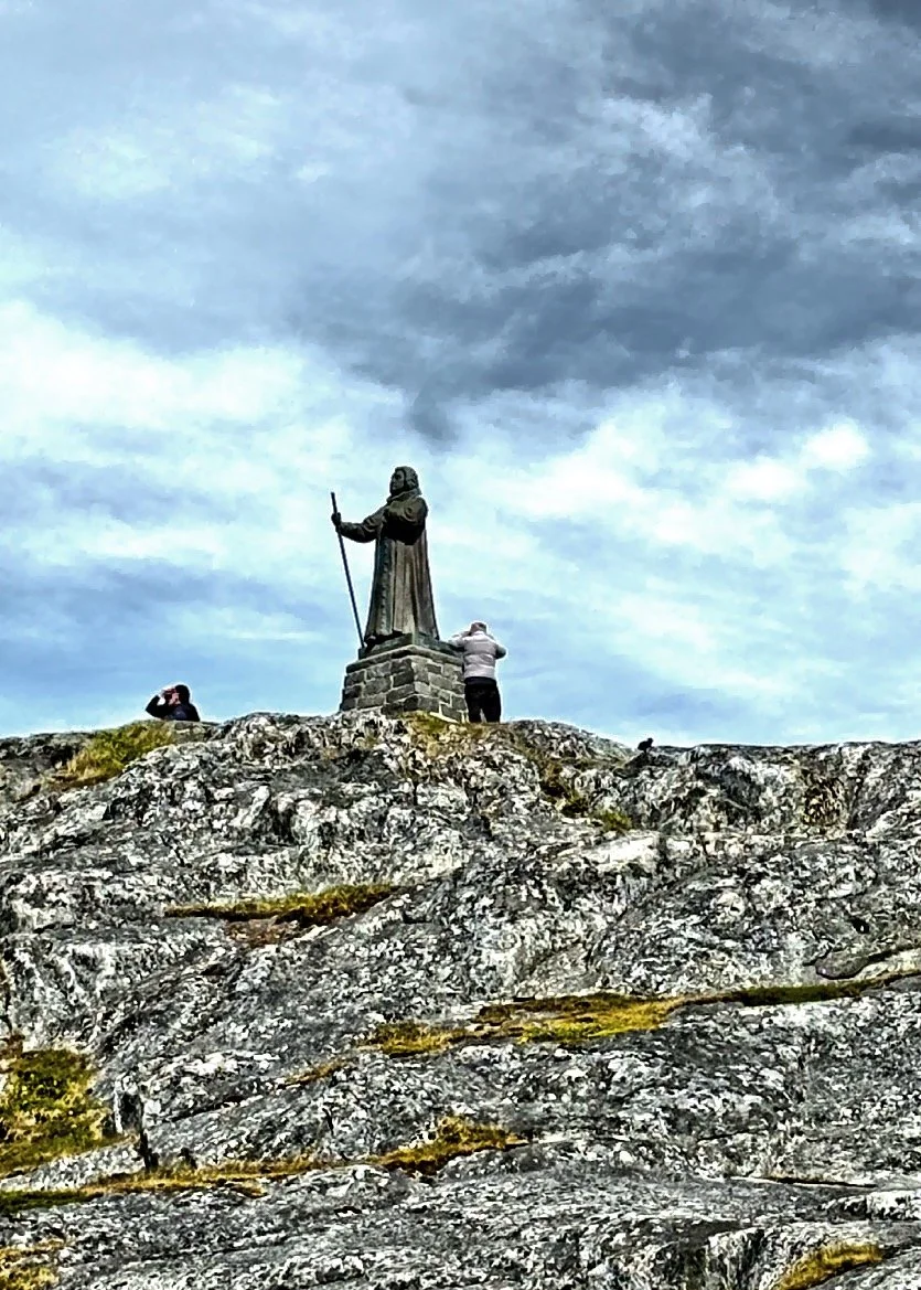  High on a rock overlooking the water is this statue of Hans Egede the Norwegian Lutheran priest and missionary who launched missions to Greenland.  