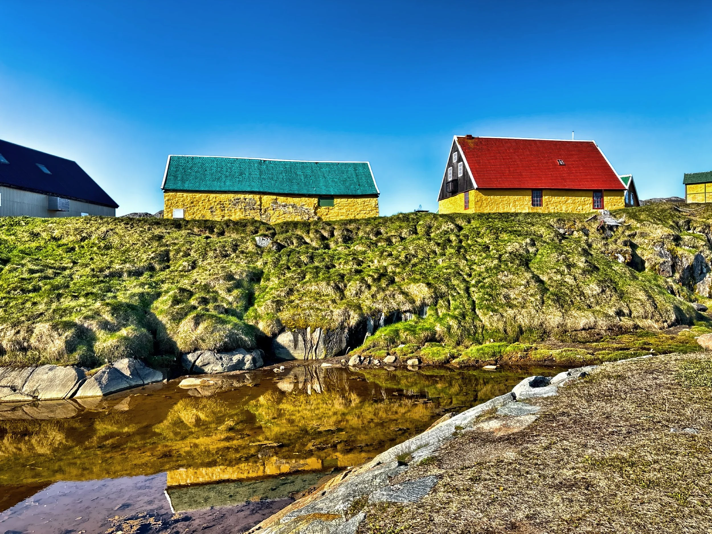  Colorfully painted houses peak out over the rocky terrain. 
