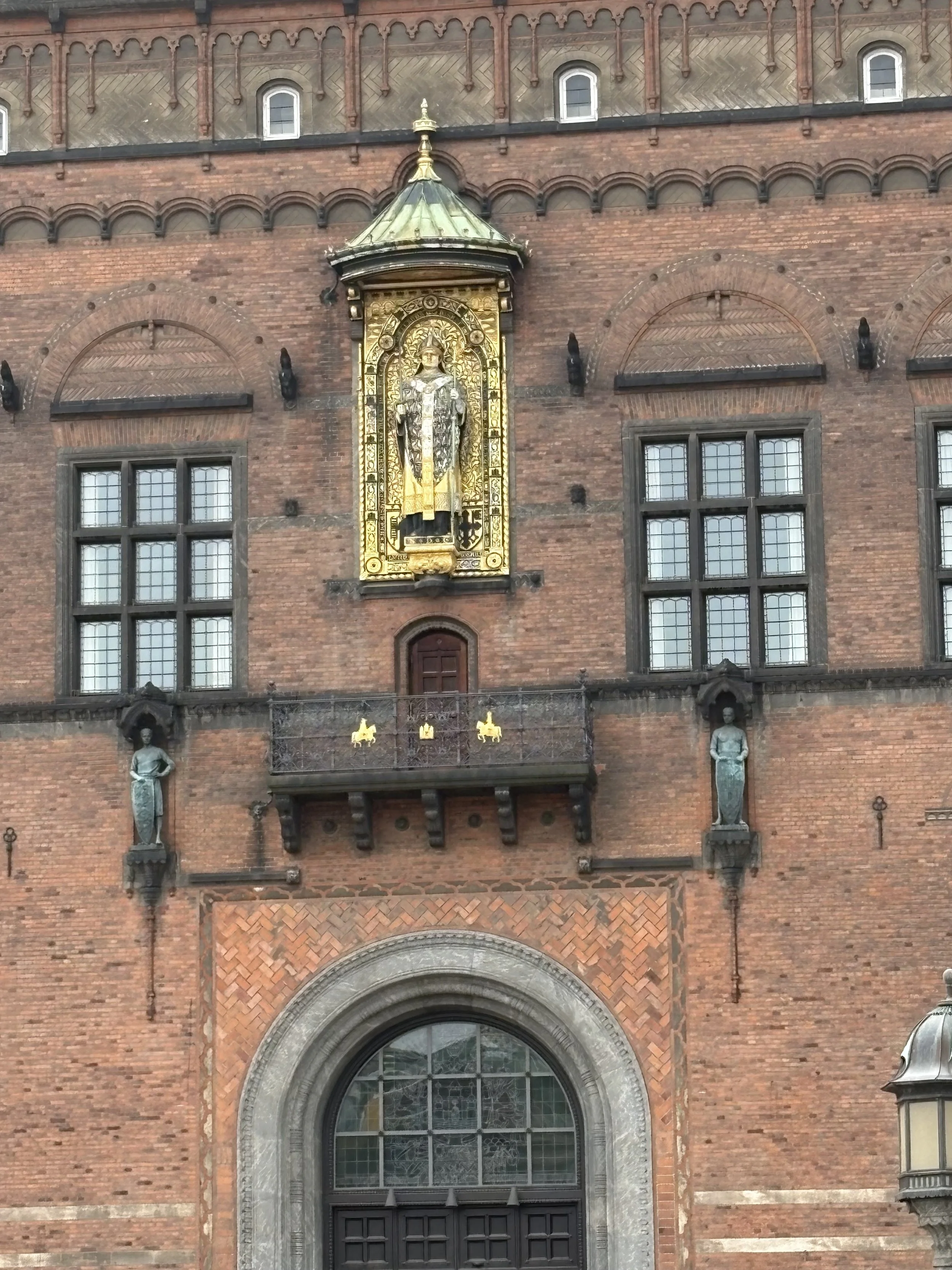  Standing above the main entrance is a gilded statue of Bishop Absalon, the 12th-century bishop / advisor to King Valdemar I. He is widely regarded as the founder of Copenhagen, having established a fortress on the site around 1160, which laid the fo