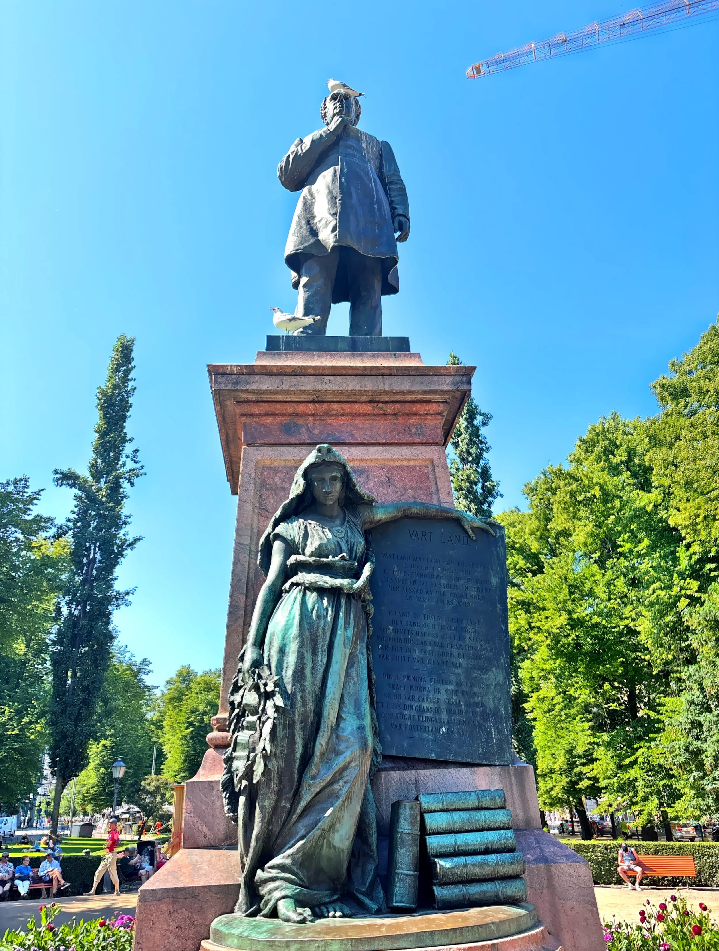  The statue of the Finland-Swedish author John Ludvig Runeberg designed and sculpted by his son Walter.  At the base of the sculpture is a young woman symbolizing Maiden of Finland.  The statue is located in the Esplandi Park.  