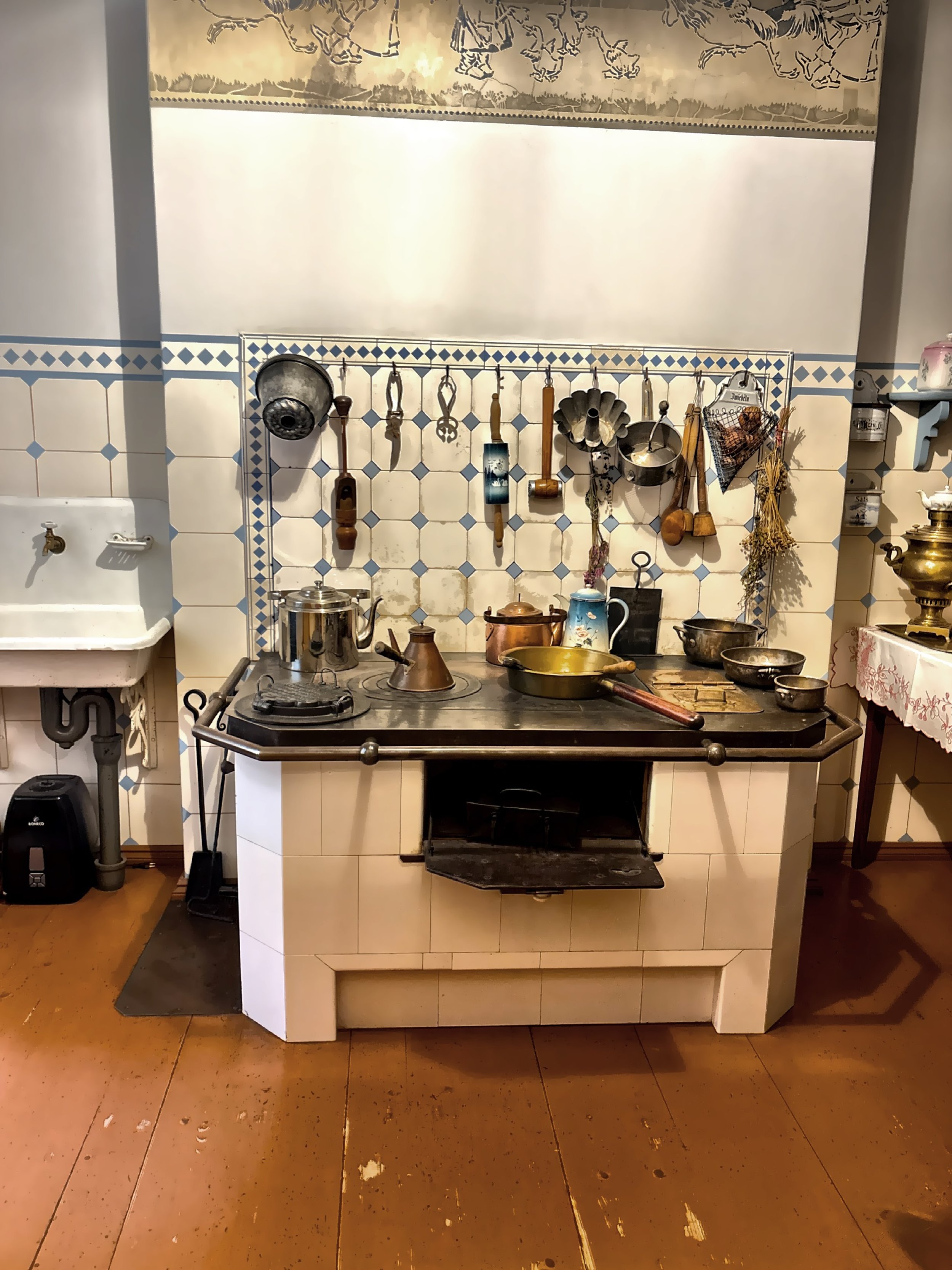  The kitchen with utensils hanging over the vintage stove,  