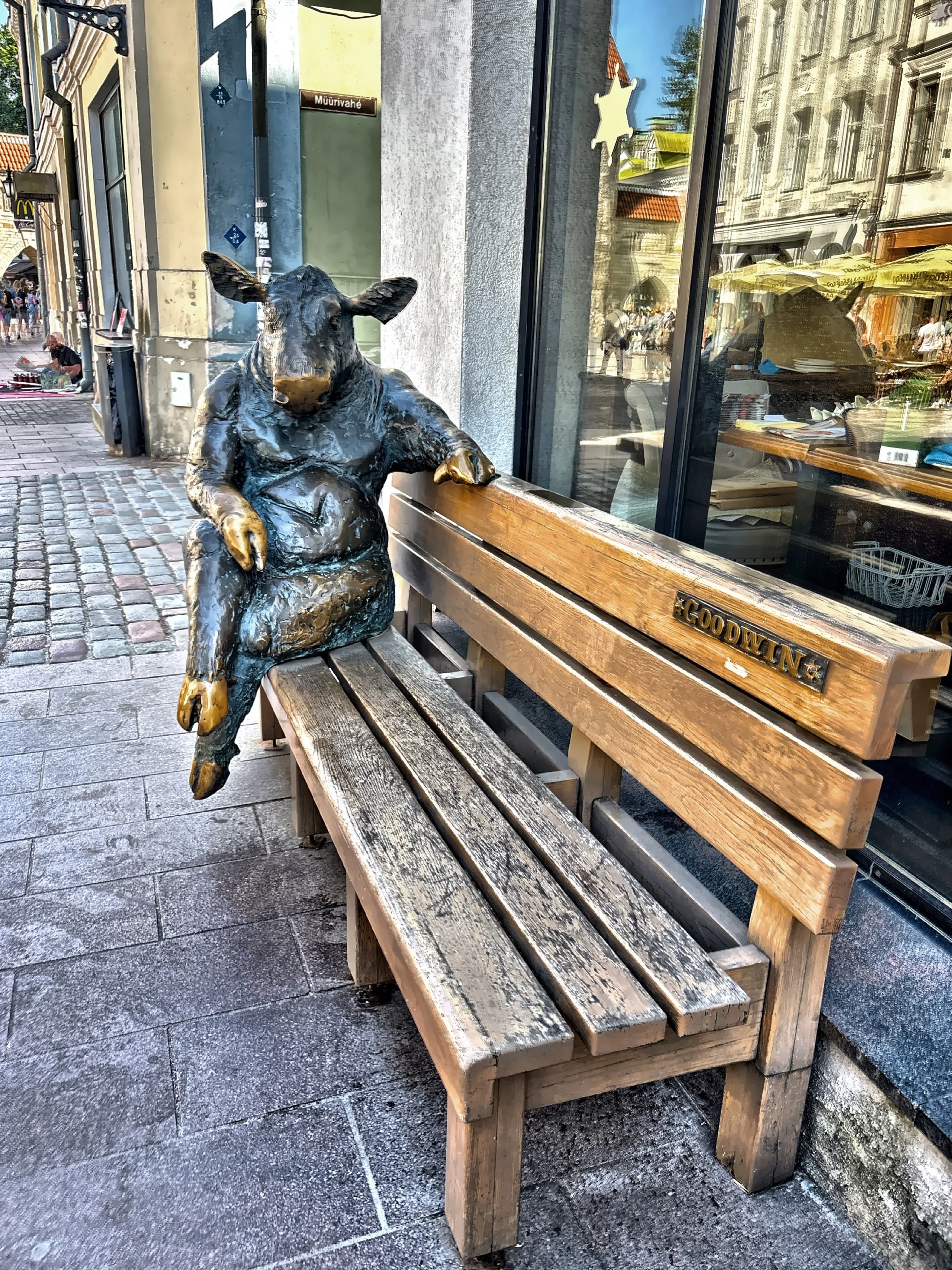  This sculpture of an anthropomorphic bull sitting on a wooden bench is called ‘Black Angus’ created by artist is Tauno Kangro in 2011. 