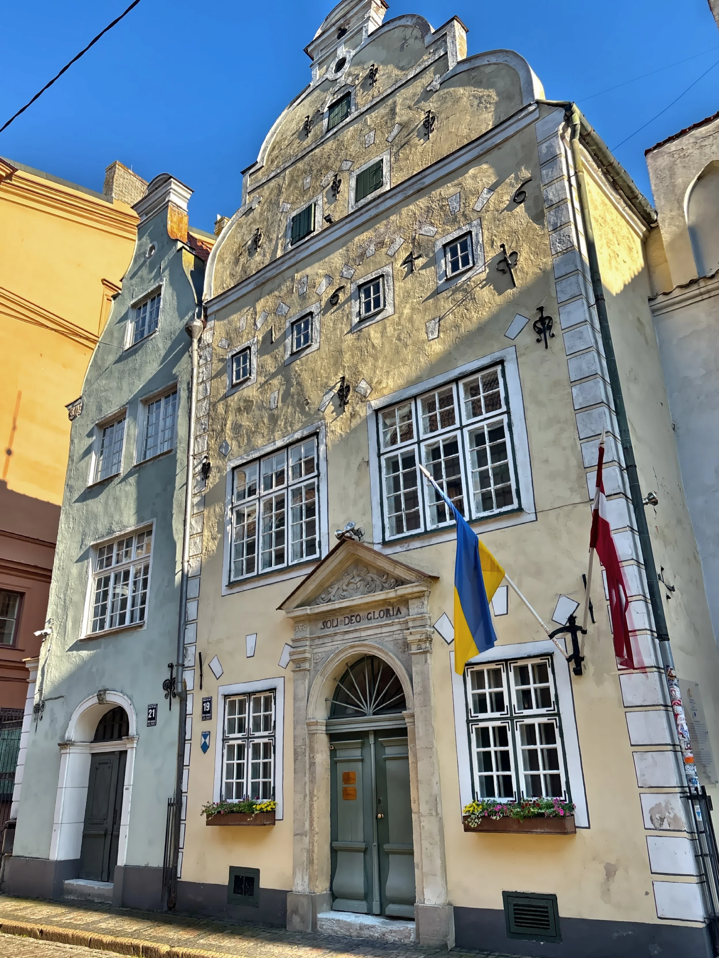  Wander past Three Brothers, the oldest stone residential buildings in the city showcasing different architectural styles.   