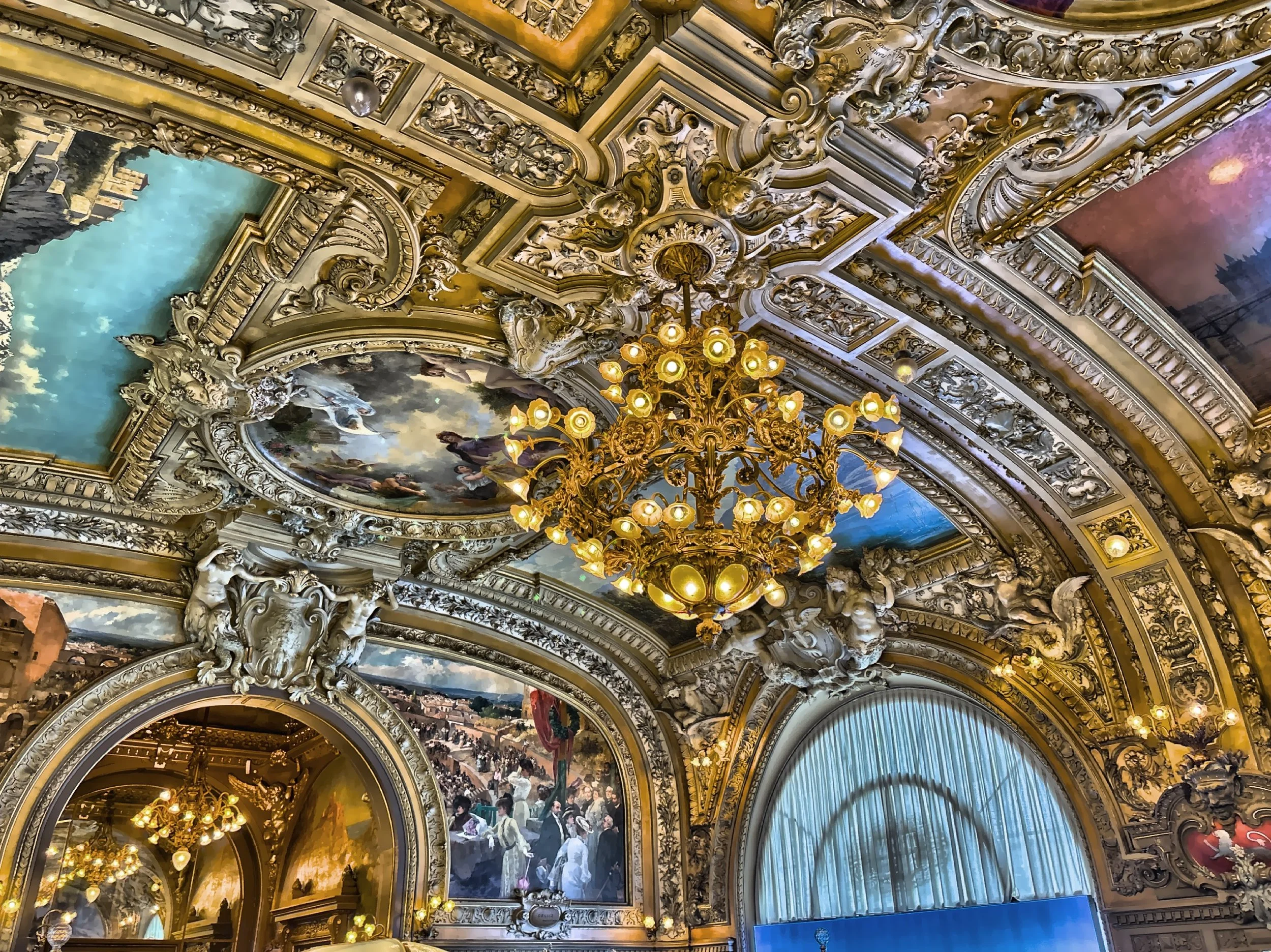  Ornate ceilings, gilded details, sparkling chandeliers, ornamental mirrors and paintings that depict various French landscapes and cities. 