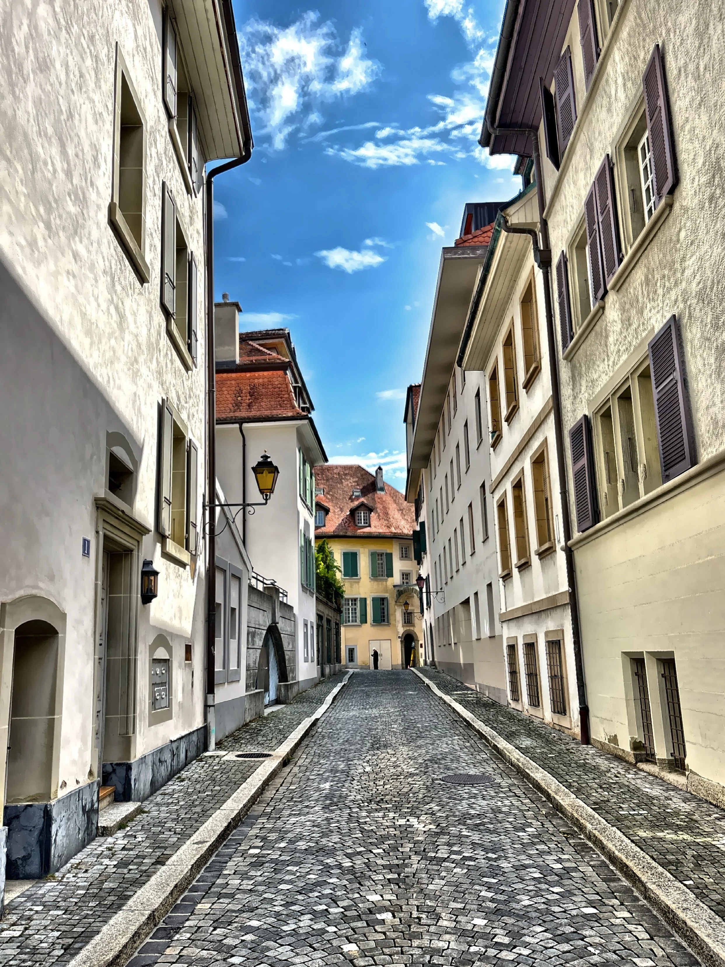 A view of Rue Charles-Vuillermet, a narrow, cobblestone street in the historic center. 