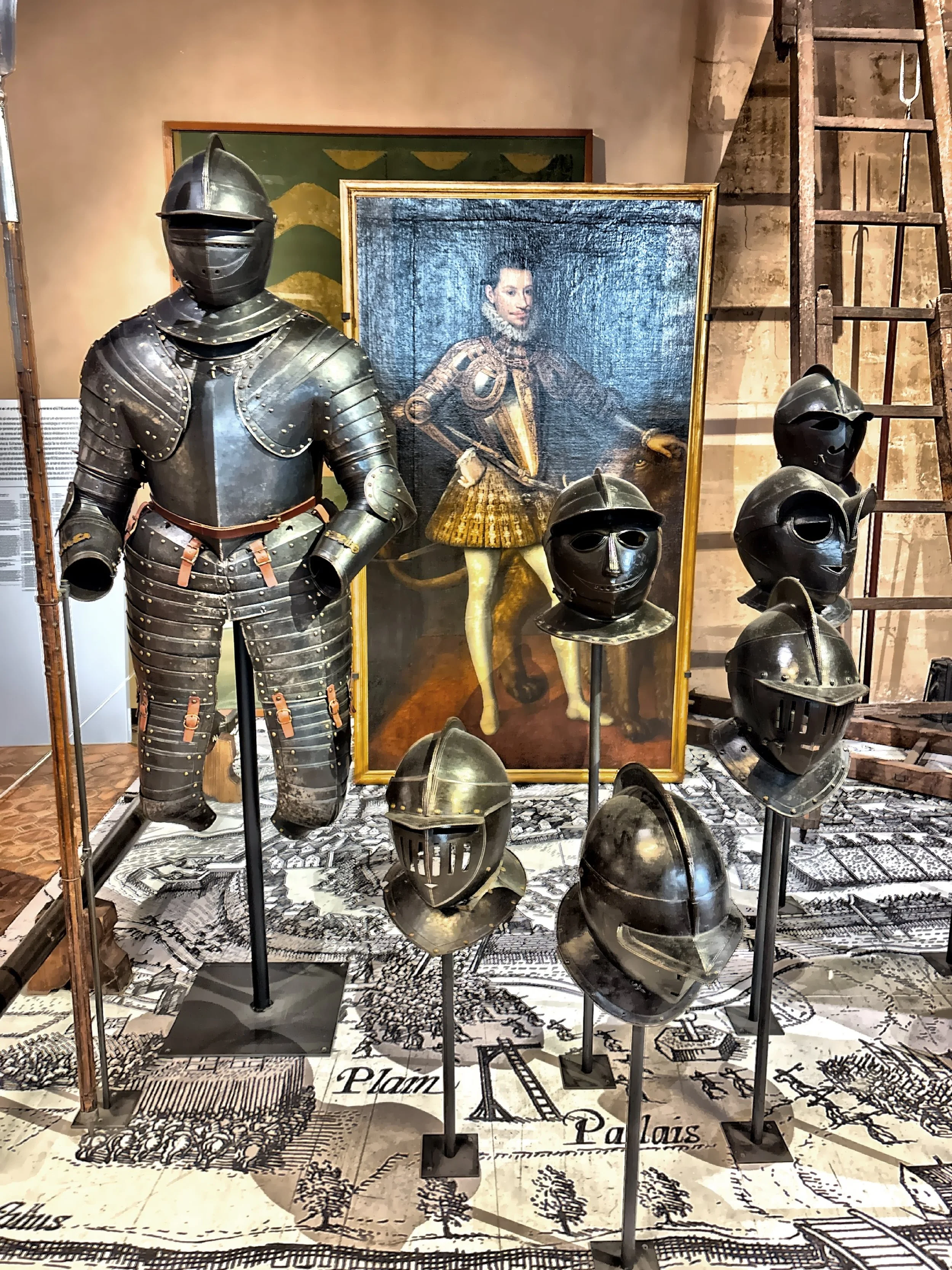  A collection of historical armor including helmets. 