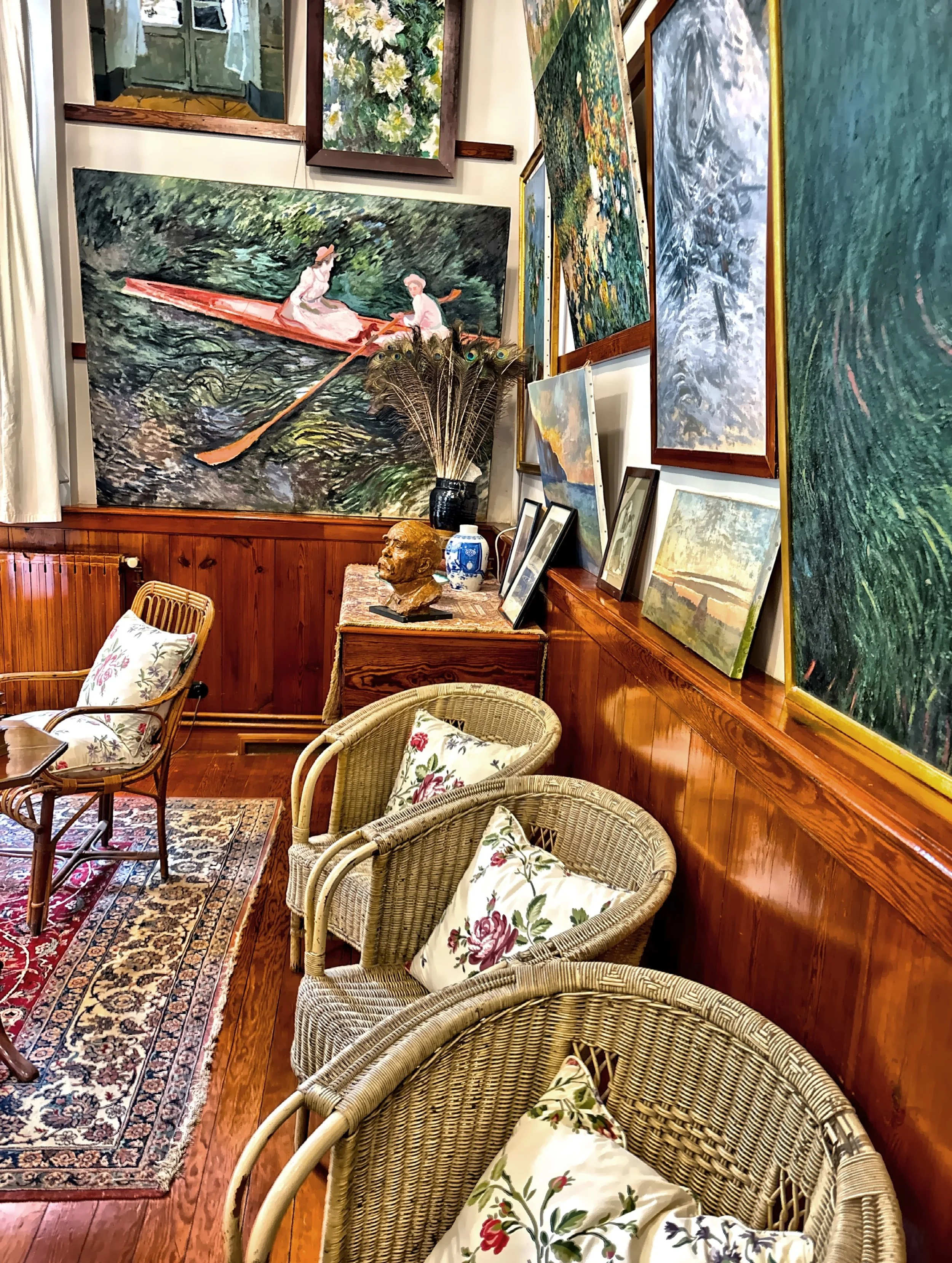  In his living room / studio with huge windows and reproductions of his paintings hanging where his originals once dried. 