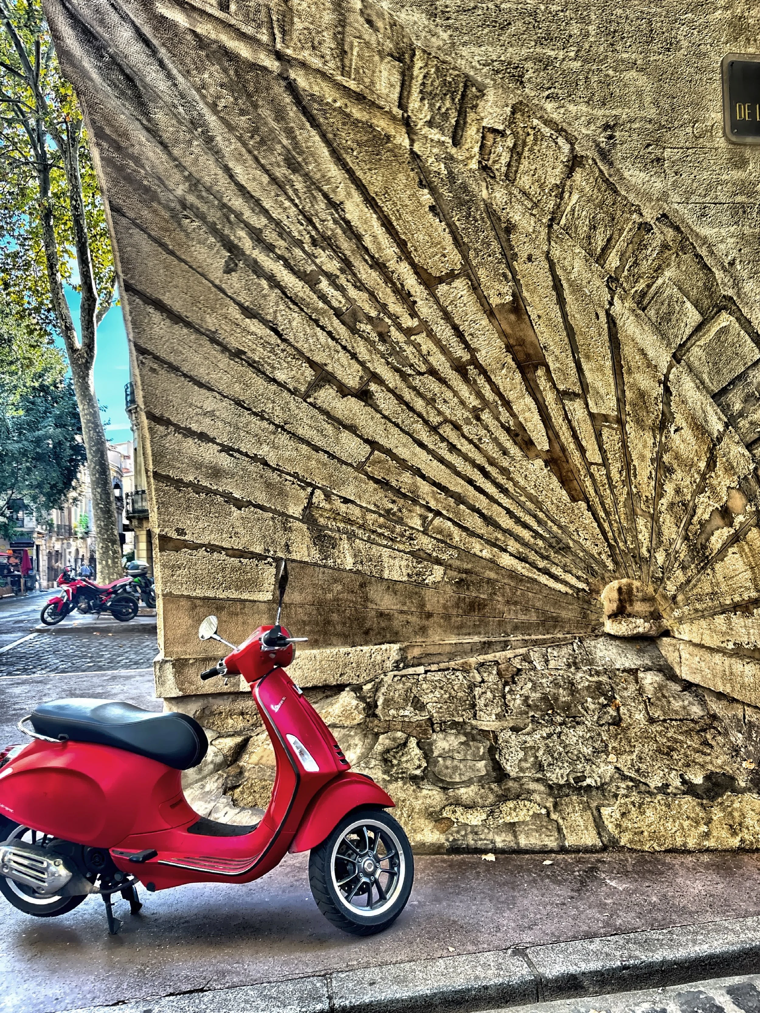  In medieval times streets were only wide enough to fit a cart, so some builders trimmed the corner of a building to prevent carts from scraping the building. Today some people use these niches for a modern day parking spot for their Vespa or bicycle