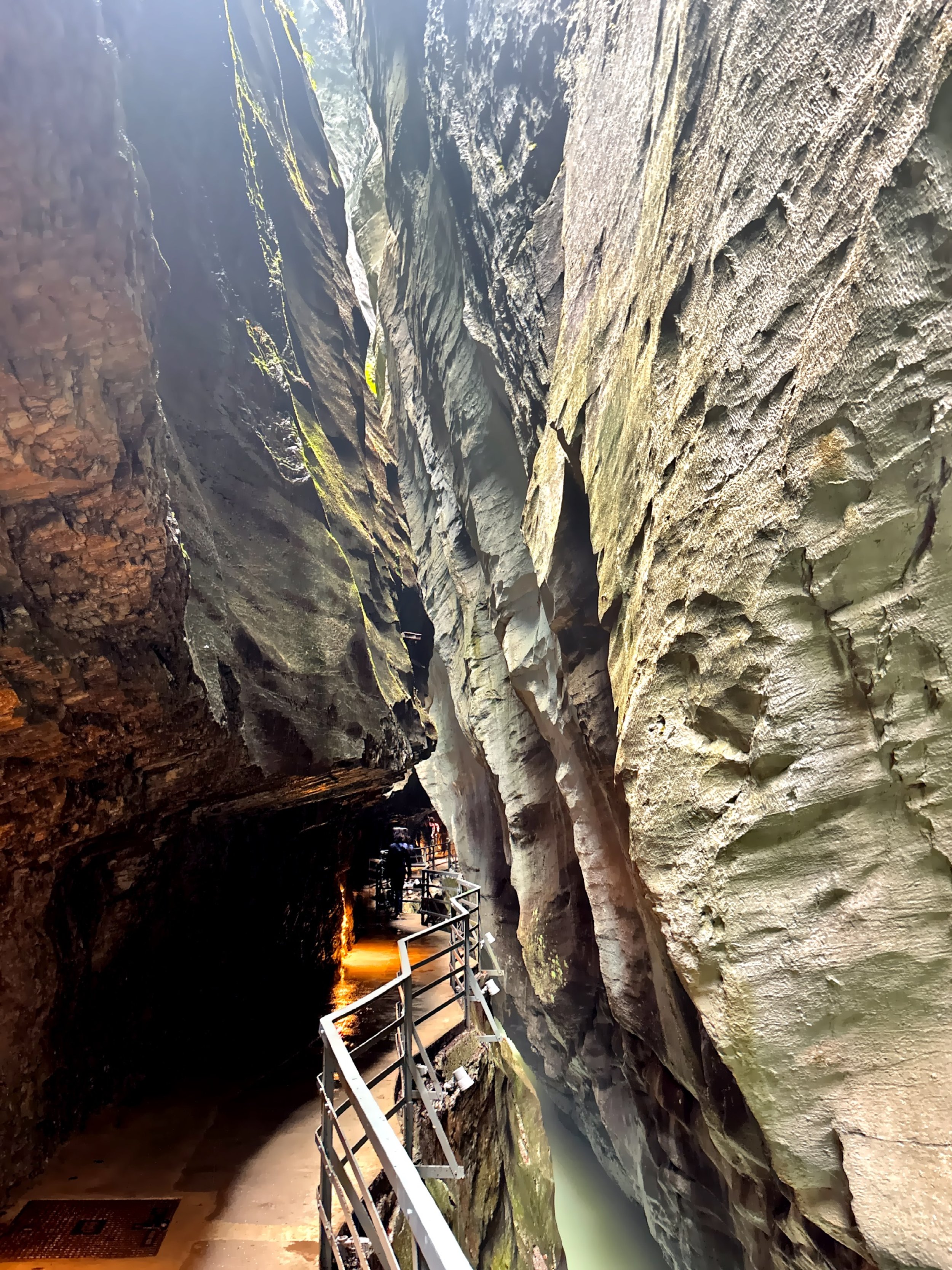  Sheer rock walls soaring above the walkway — nature’s cathedral of stone. 