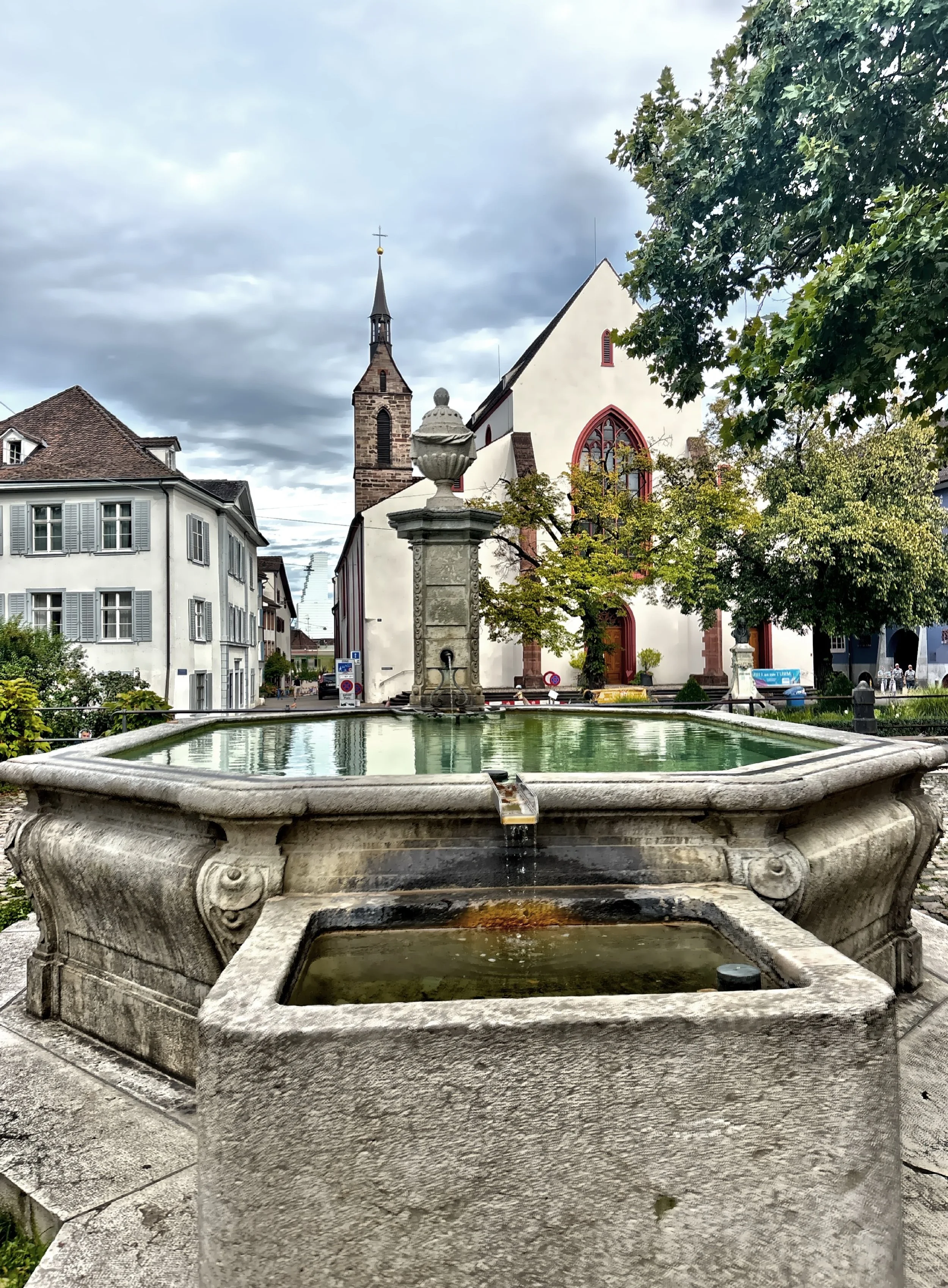  The tower of St. Peter’s Church, one of Basel’s oldest and most historically significant religious structures, rises near one of the many unique fountains that dot the city. 