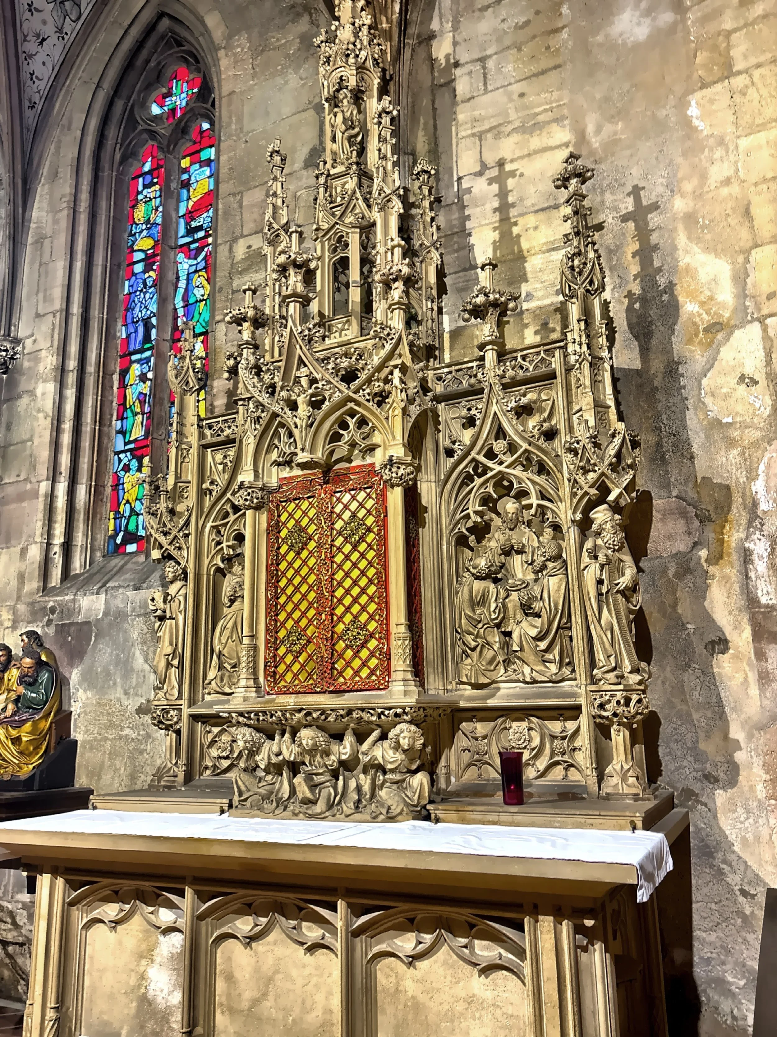 The elaborate stone carving and gilded doors of this altarpiece. 