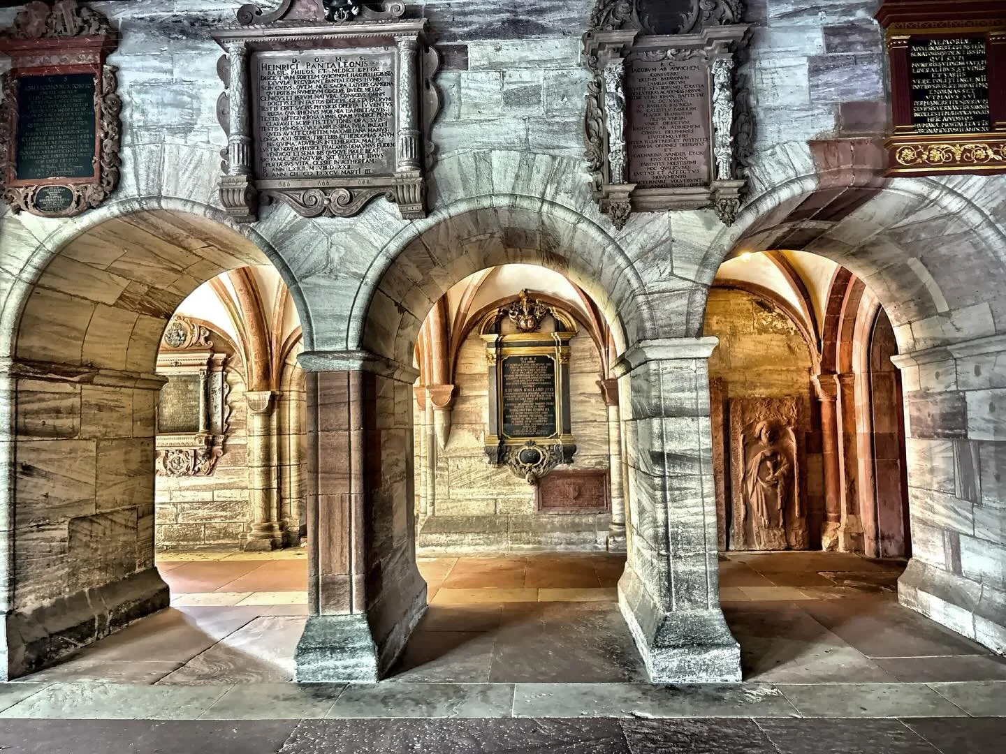 Interior arches of the Basel Minster, a landmark building in Basel, Switzerland. Originally a Roman Catholic cathedral, it is now a Reformed Protestant church. 
The architecture is a blend of Romanesque and Gothic styles, constructed primarily betwee