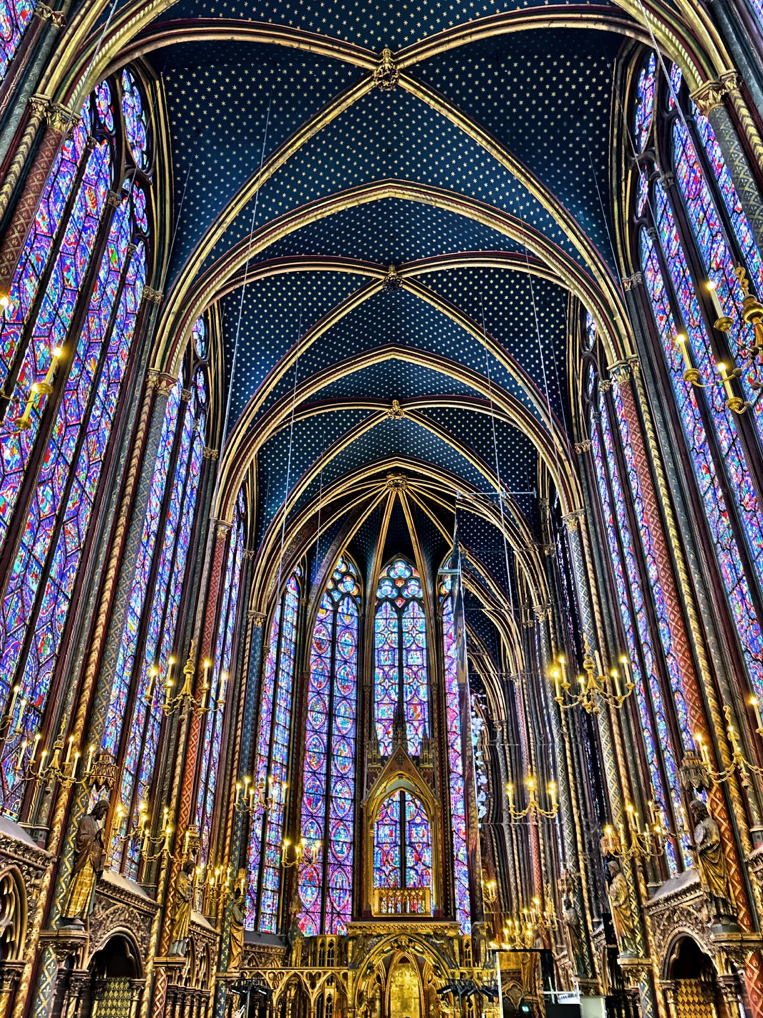  Vaulted ceiling, chandeliers and stained glass fill the upper chapel. 