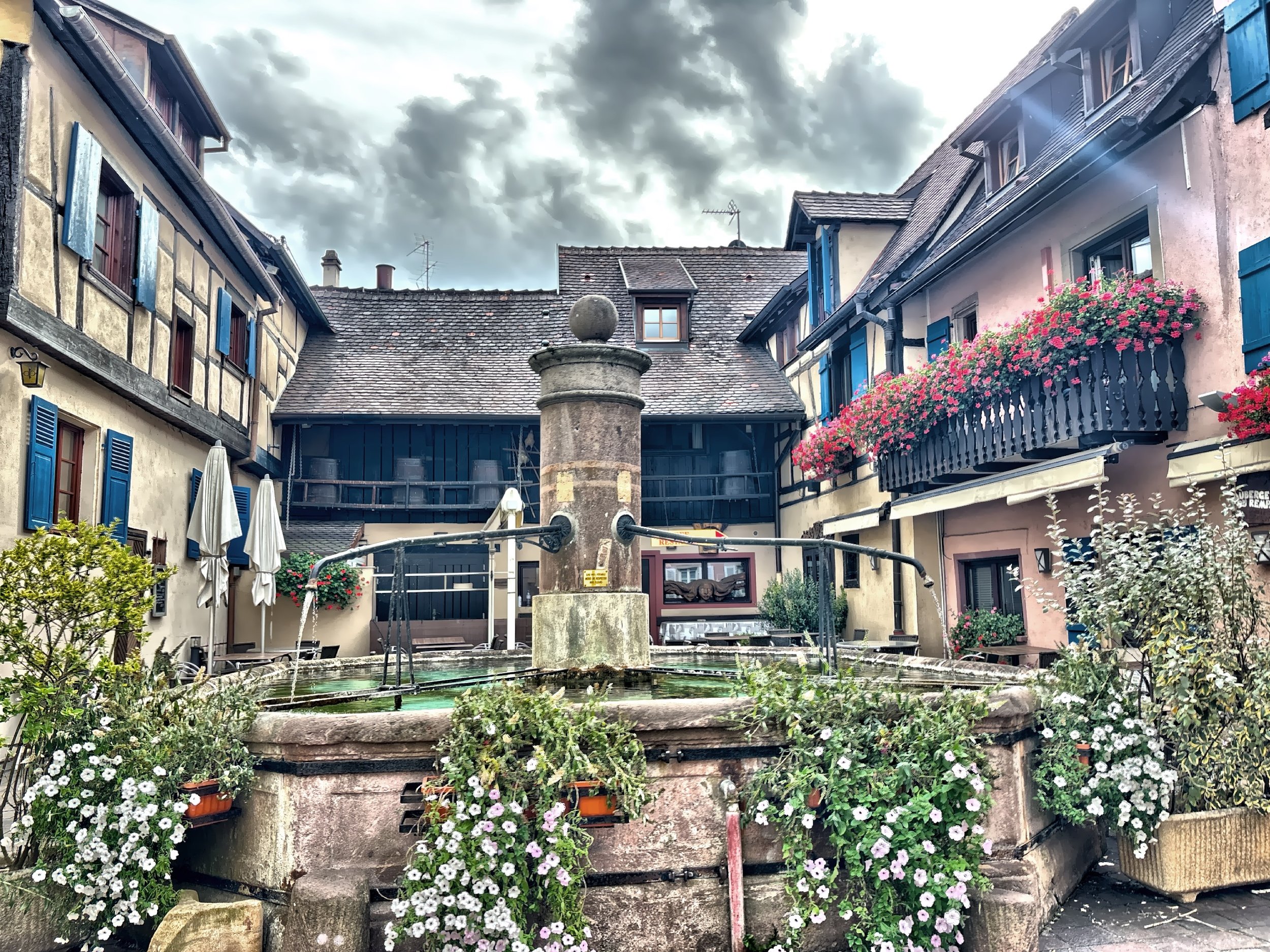  Water flows softly in a fountain that has watched centuries pass in Eguisheim. 
