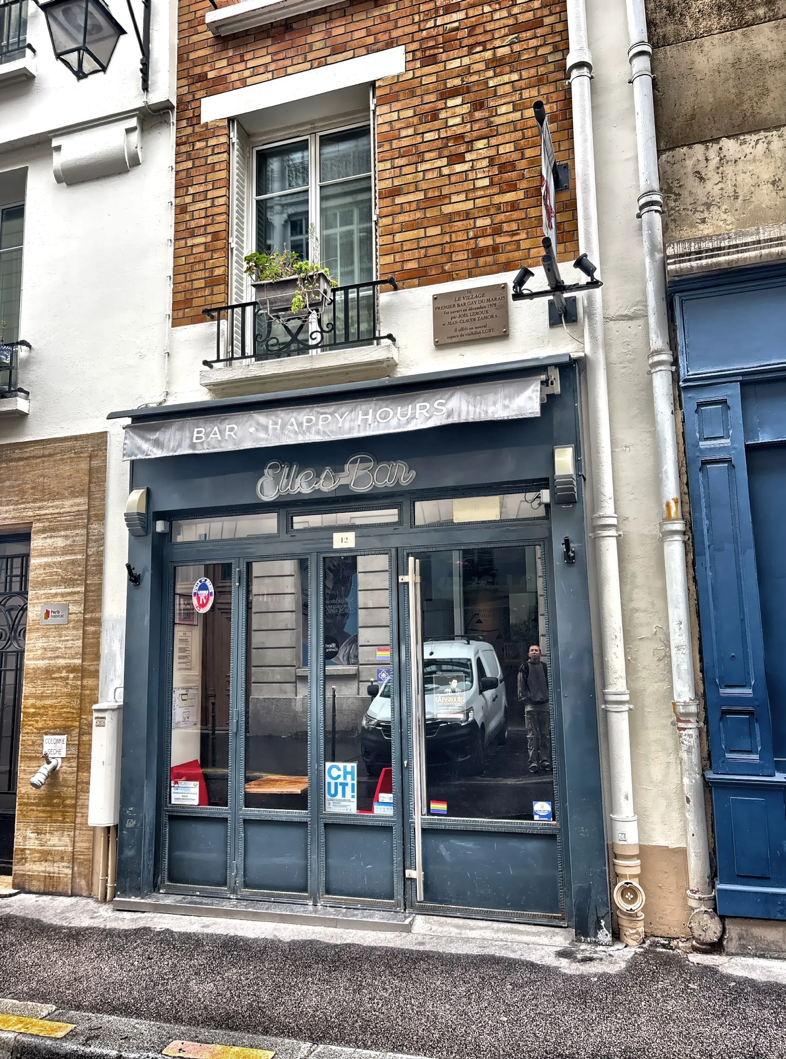   Elle’s Bar  originally opened in the Marais under the name  Le Village , becoming Paris’s first openly gay business. It marked a turning point in the city’s social history as the first gay bar to have windows facing the street and to charge the sam