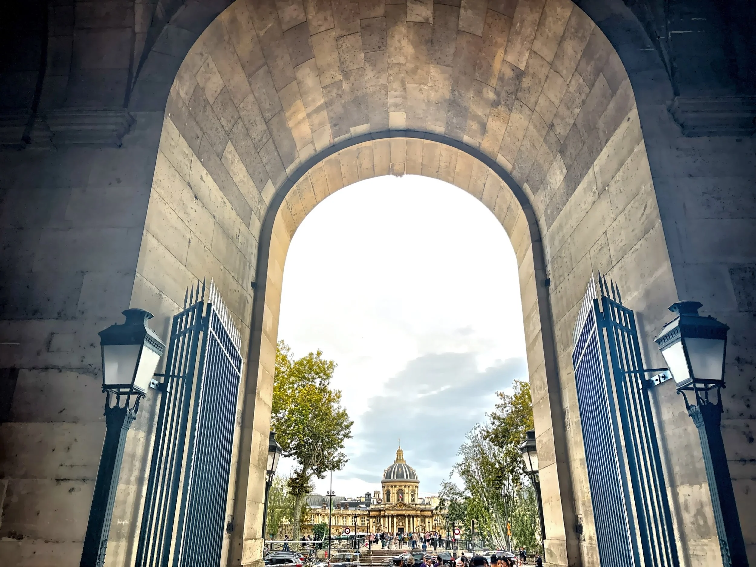  The Institute of France, designed by architect Louis Le Vau in the late 17th century, is seen through the arched gateway. 