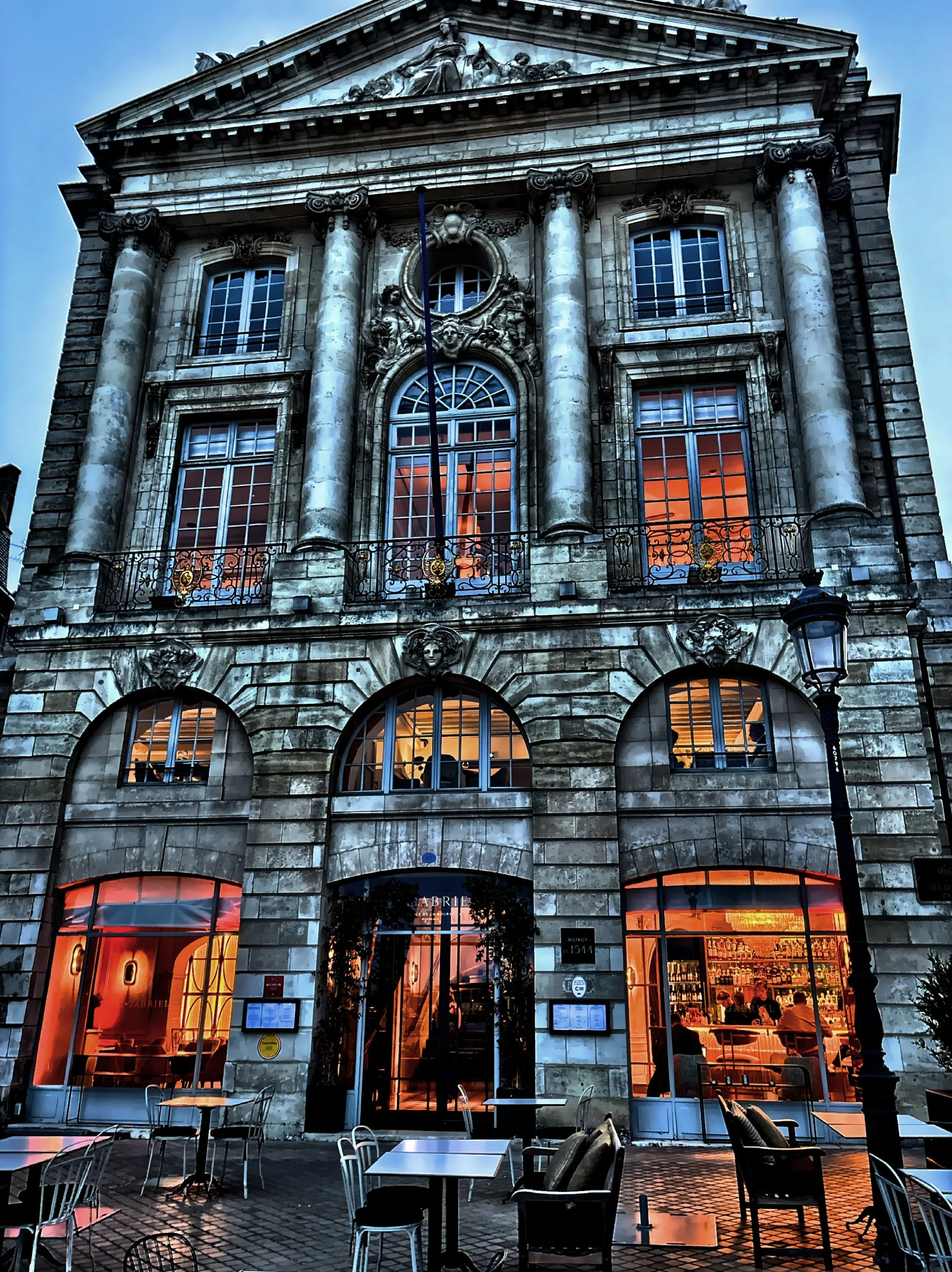  The lit windows of the Art Deco-inspired bar of Le Gabriel. 