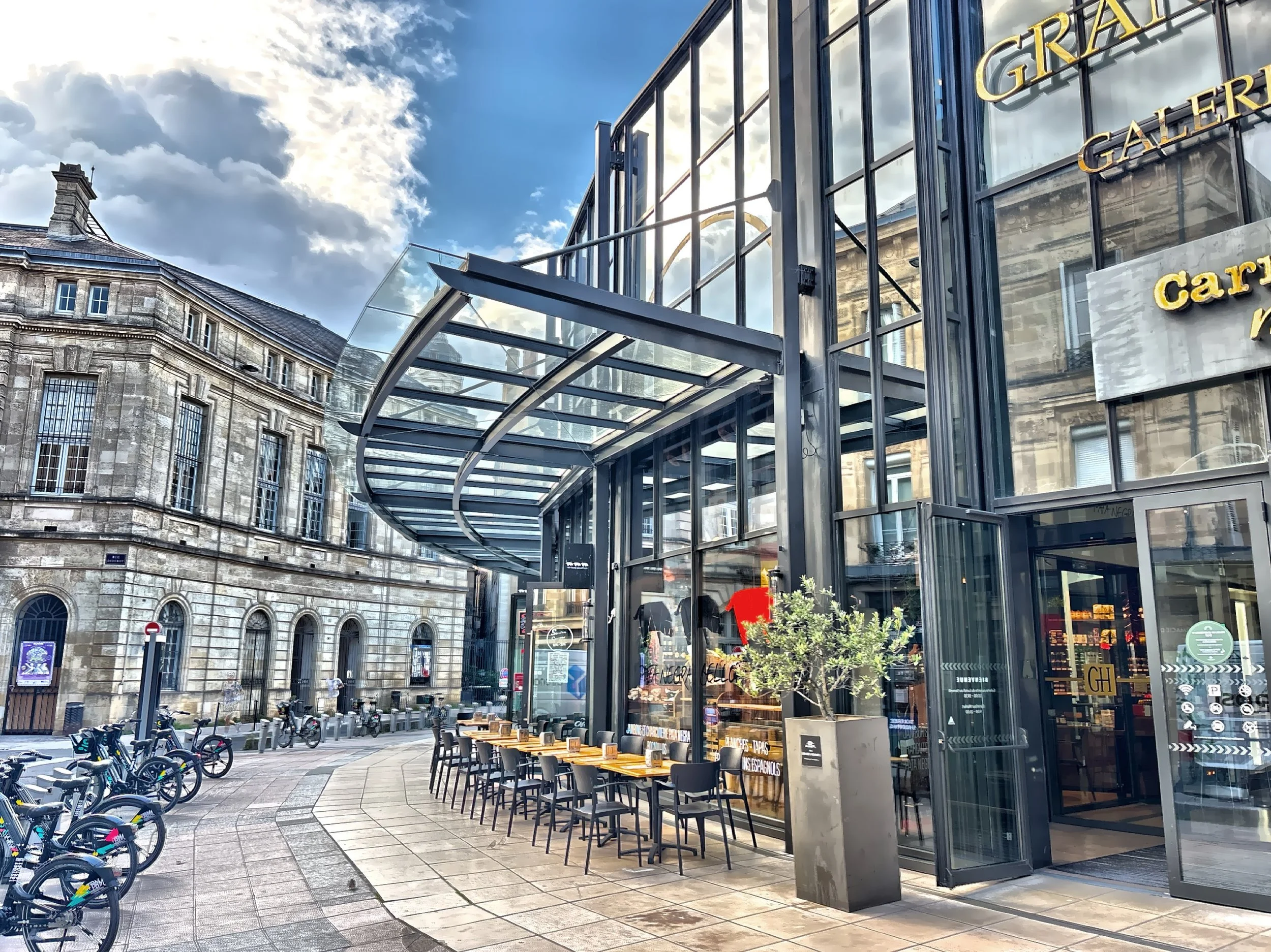  This modern glass building stands in sharp contrast to the surrounding historic structures. 