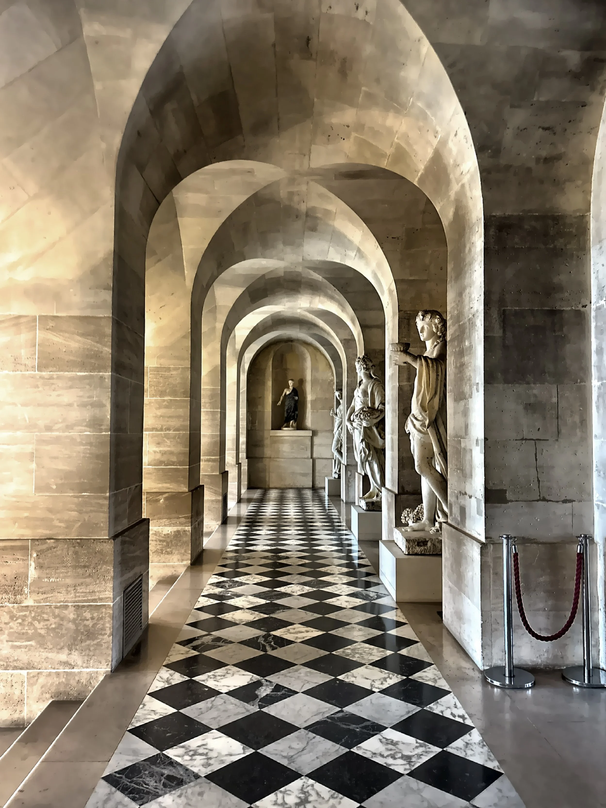  Marble statues line this historic hallway. 