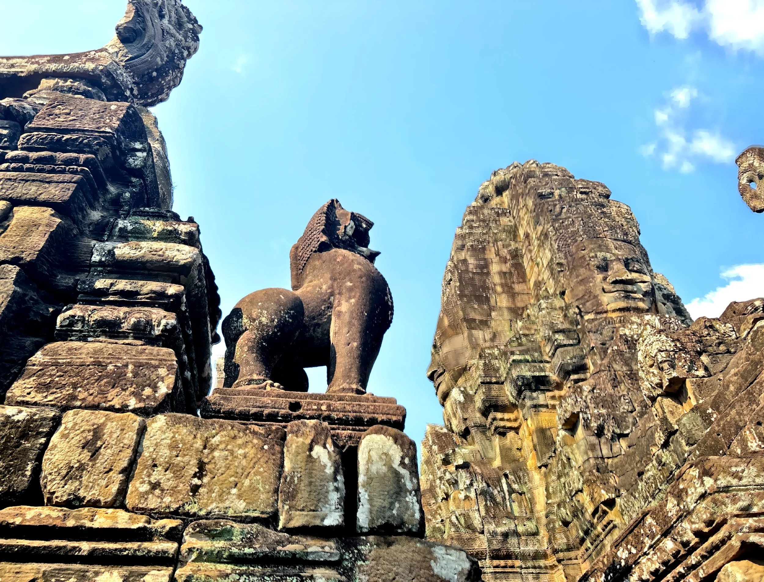  Looking up: faces emerging from the towers like guardians of Angkor Thom. 