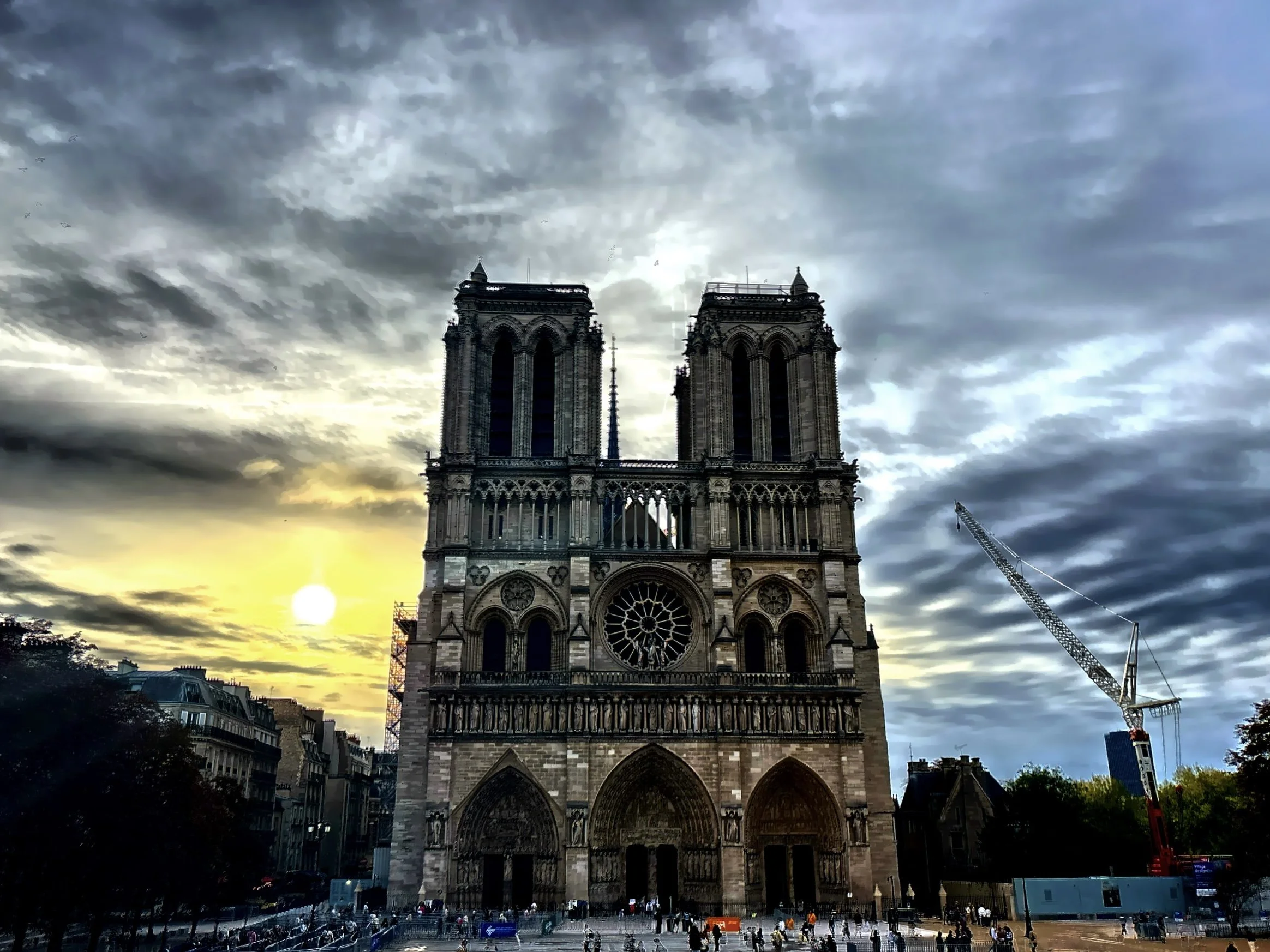  The iconic Gothic facade featuring twin towers, detailed stone sculptures, and a central rose window. 