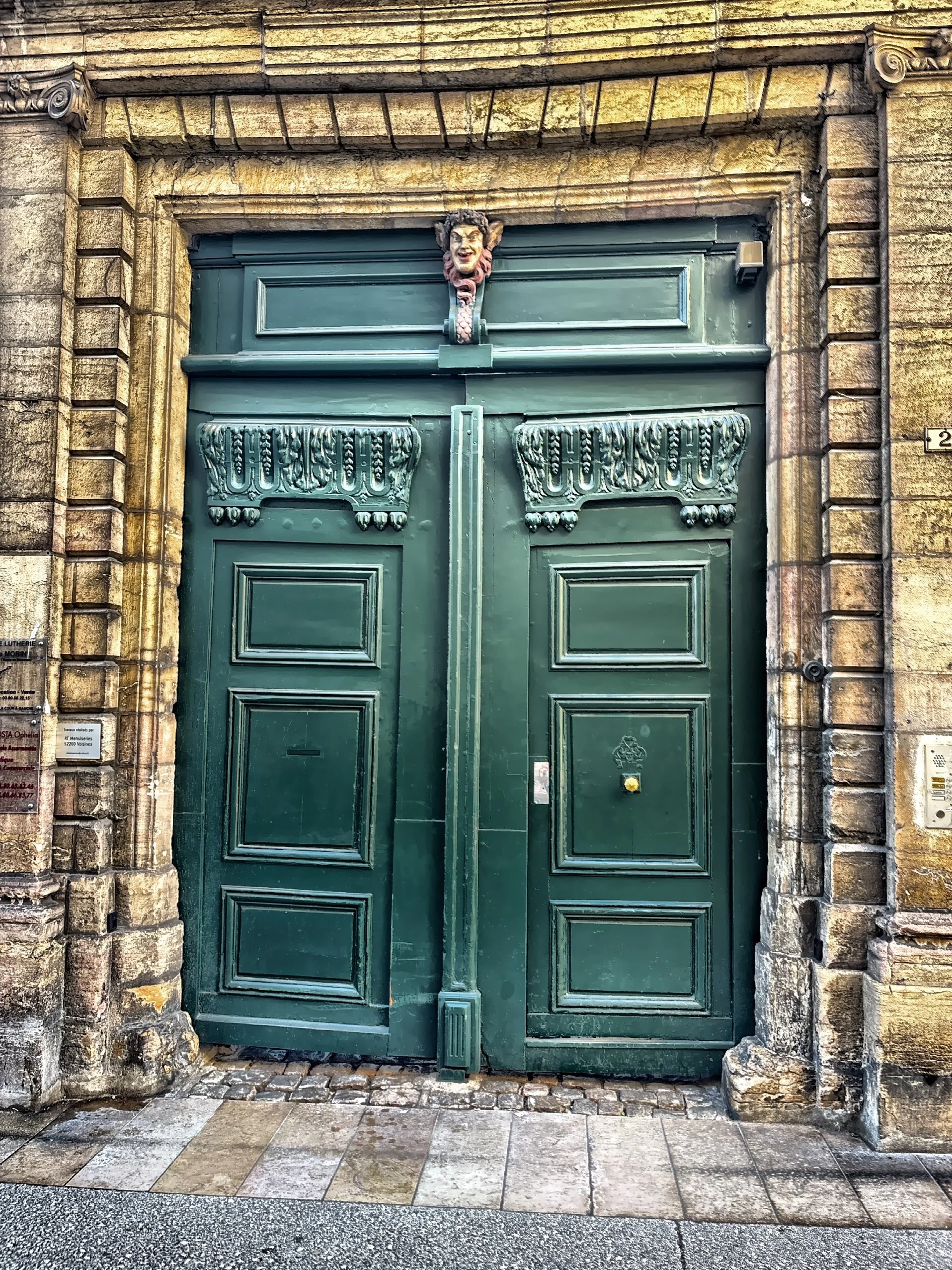  A classic decorative double door with a hand-carved mascaron above.  
