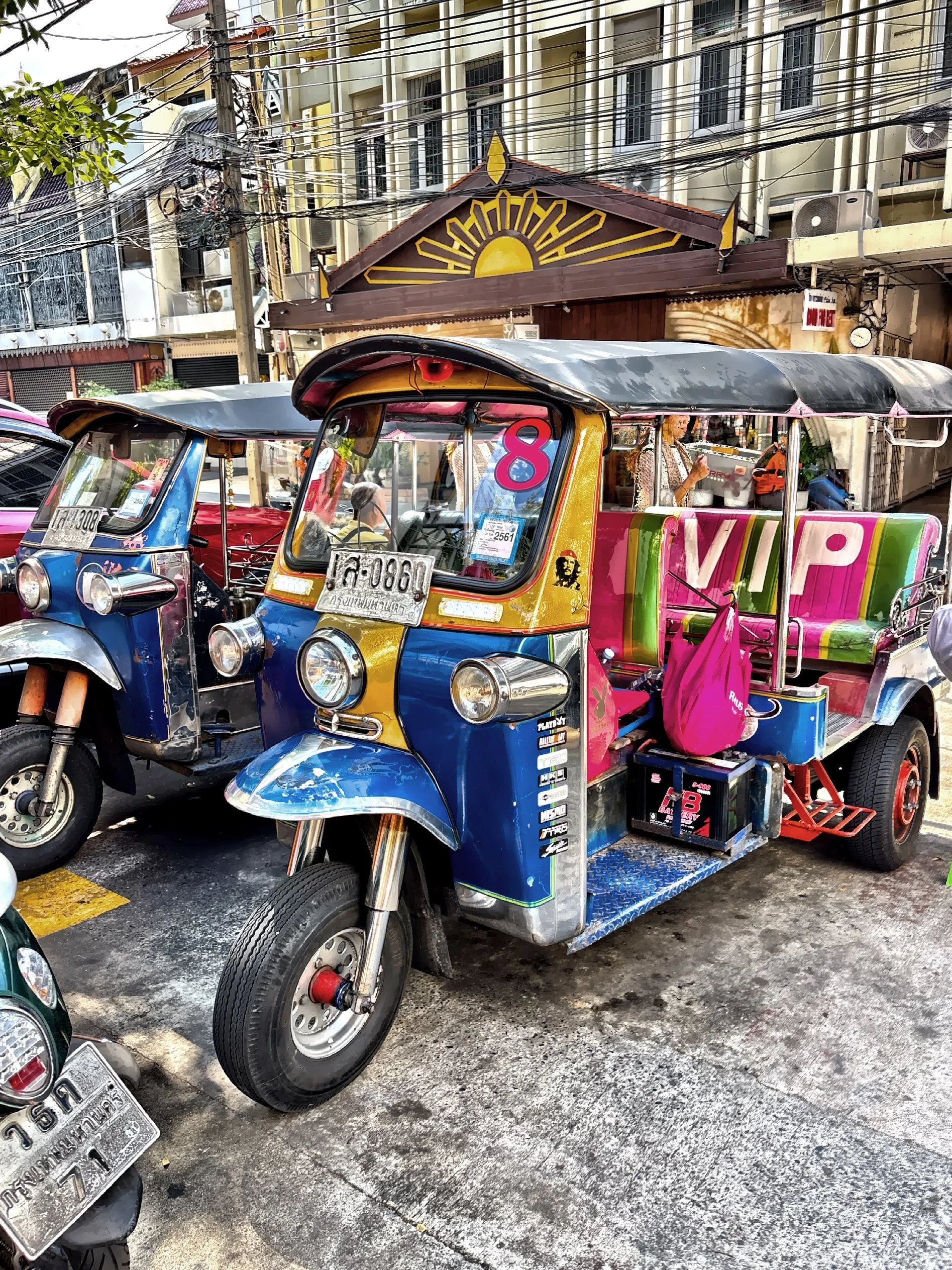  A vibrant tuk-tuk, an iconic three-wheeled motorized rickshaw. 