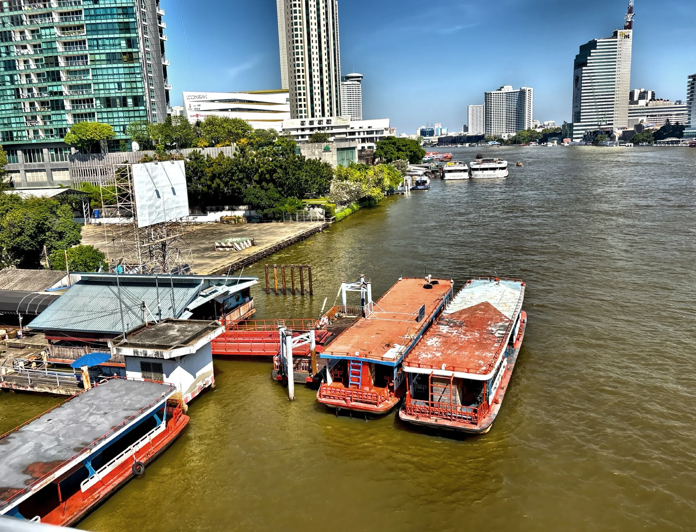  A view of the Chao Phraya River and ferry boats at a pier.  