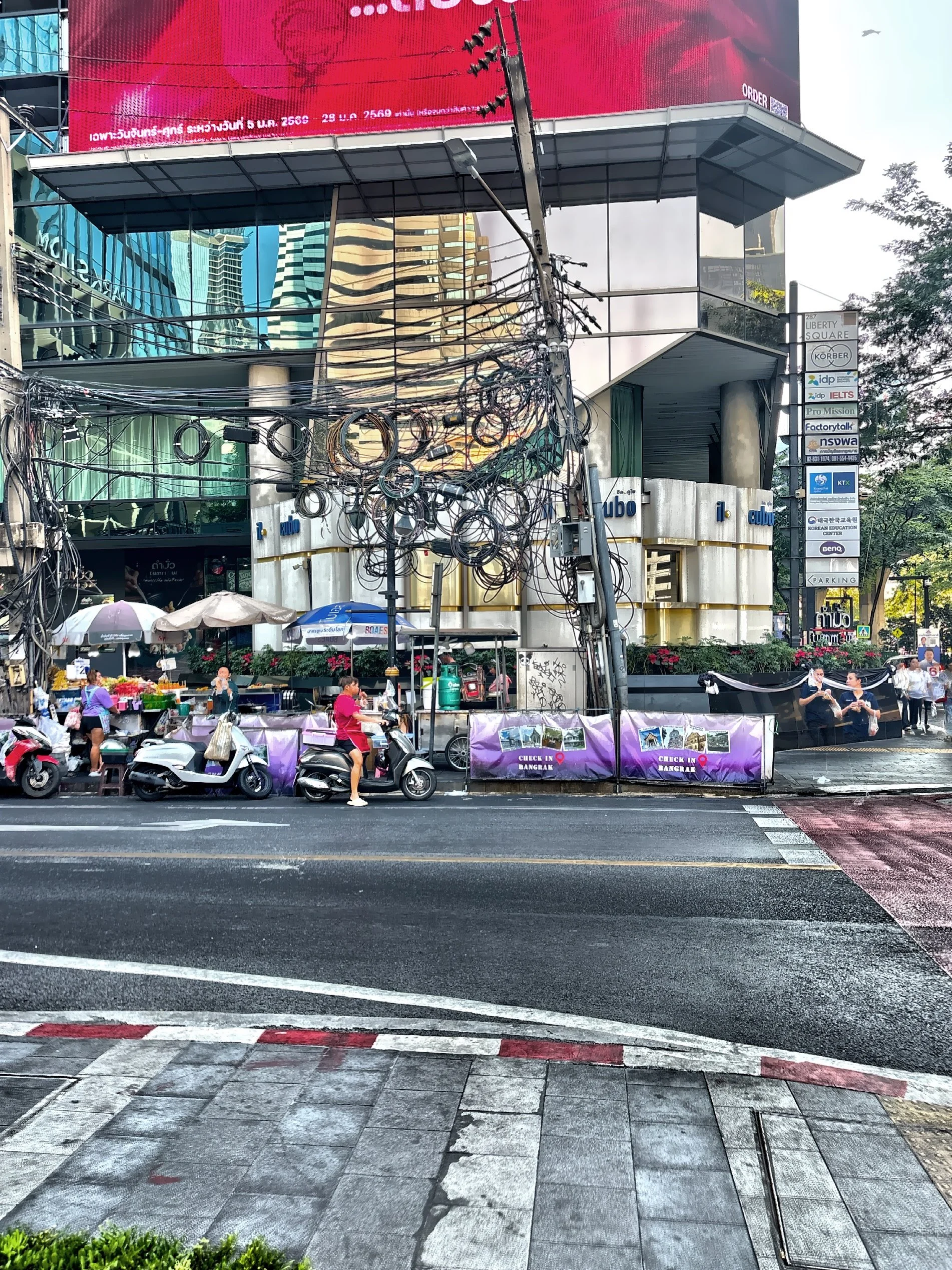  Motorbike taxis in Bangkok are popular, fast and affordable. While overhead wire rolls can look chaotic, hey are basically a mix of planned slack and ongoing patchwork expansion in a fast-growing city. 
