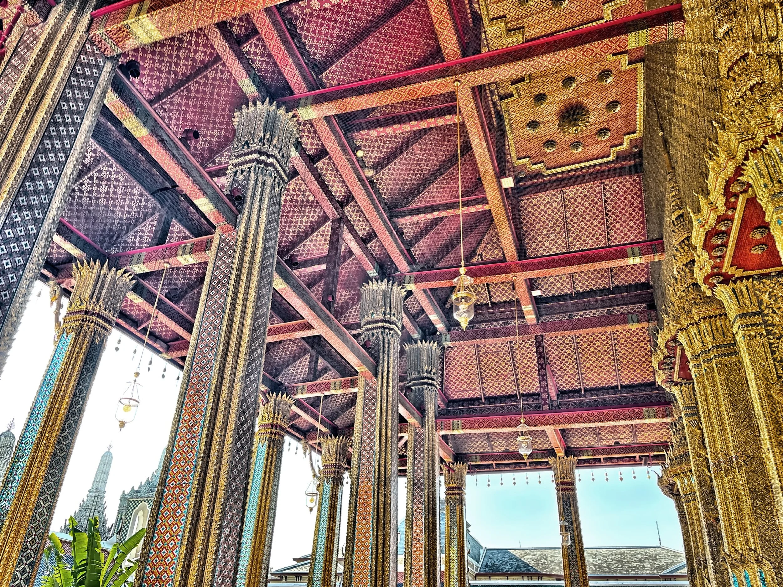  The ornate ceiling of the Wat Phra Kaew with intricate wood carvings, red lacquer and gold leaf. 
