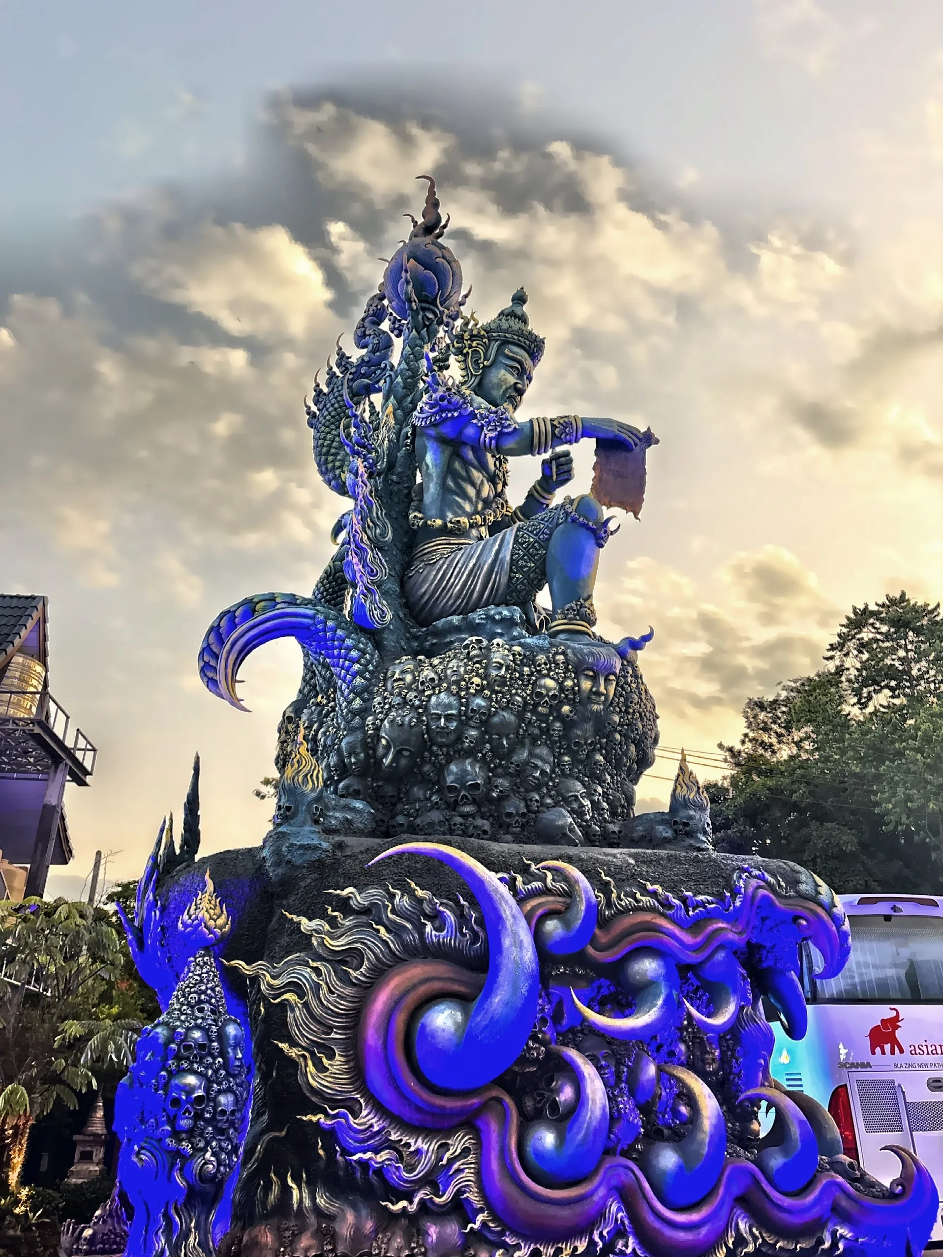  A deity siting atop a mound of skulls. 