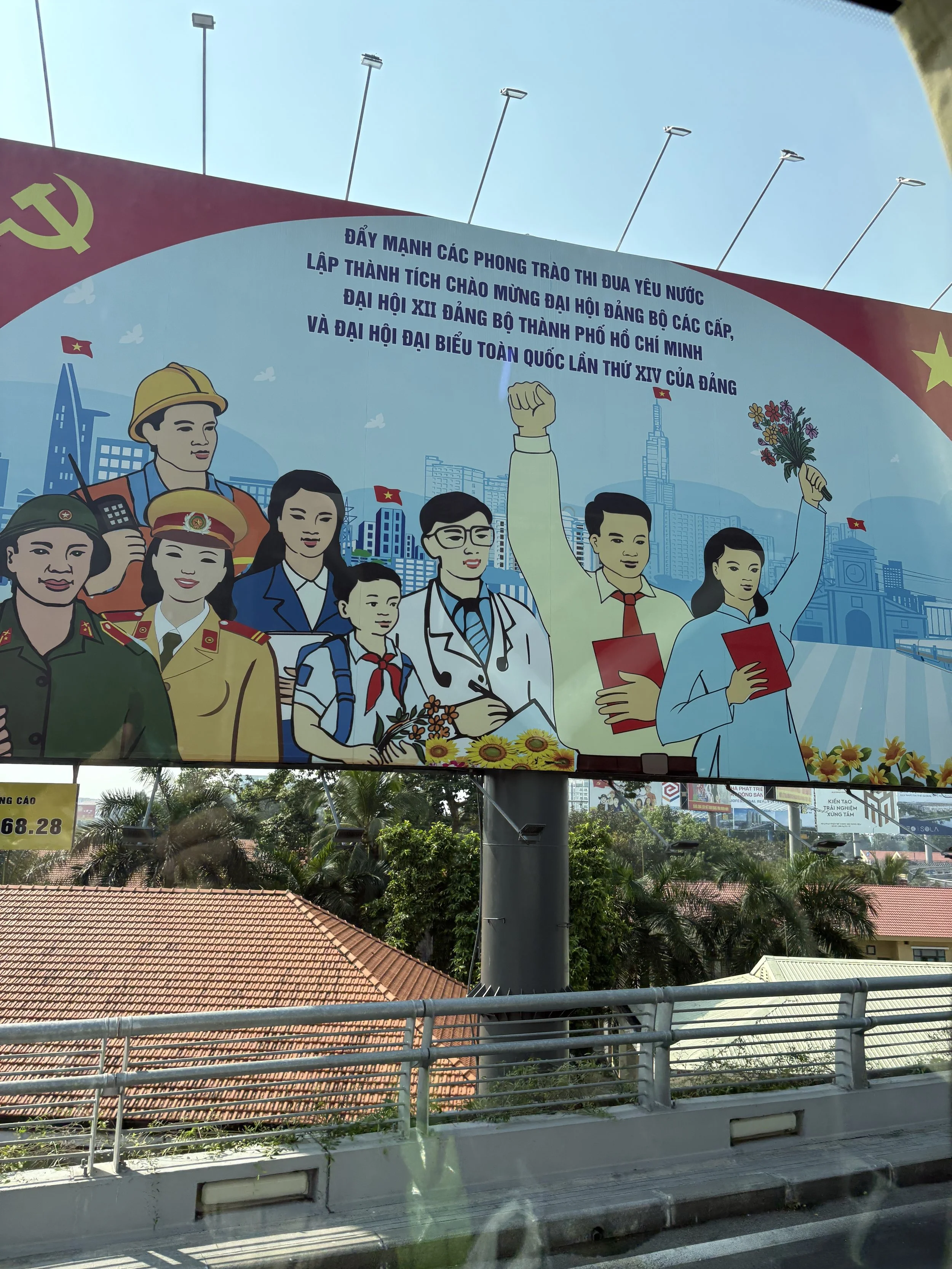  A billboard featuring Vietnamese political propaganda celebrating the upcoming Communist Party congresses and encoring emulation moments. 