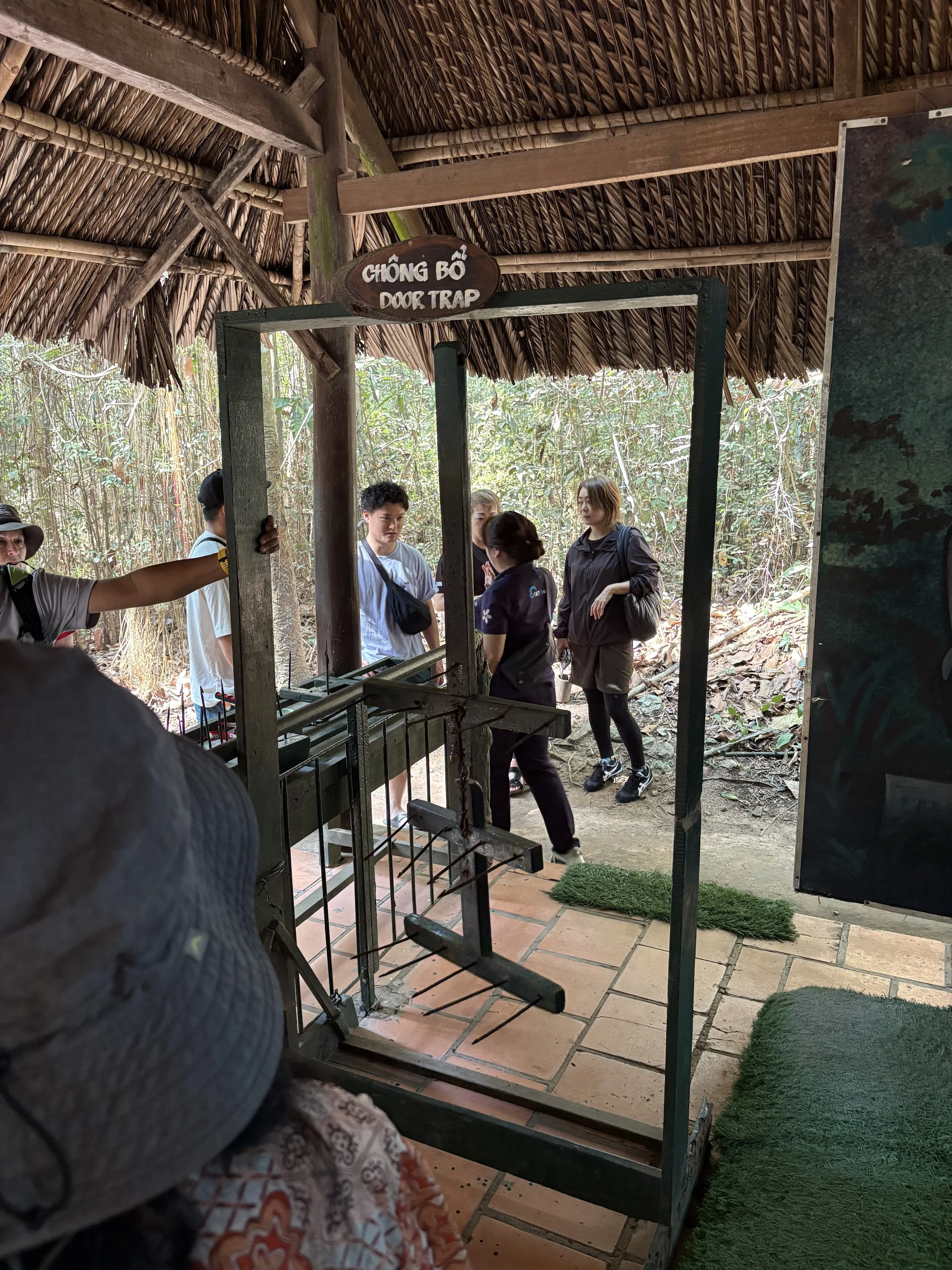  This is a replica of a Chong Bo door trap.  It would be suspended above a door and held in place by a tripwire.  When the soldier opens the door, the weighted frame swings down with great force and impales the victim’s torso, stomach and groin area 
