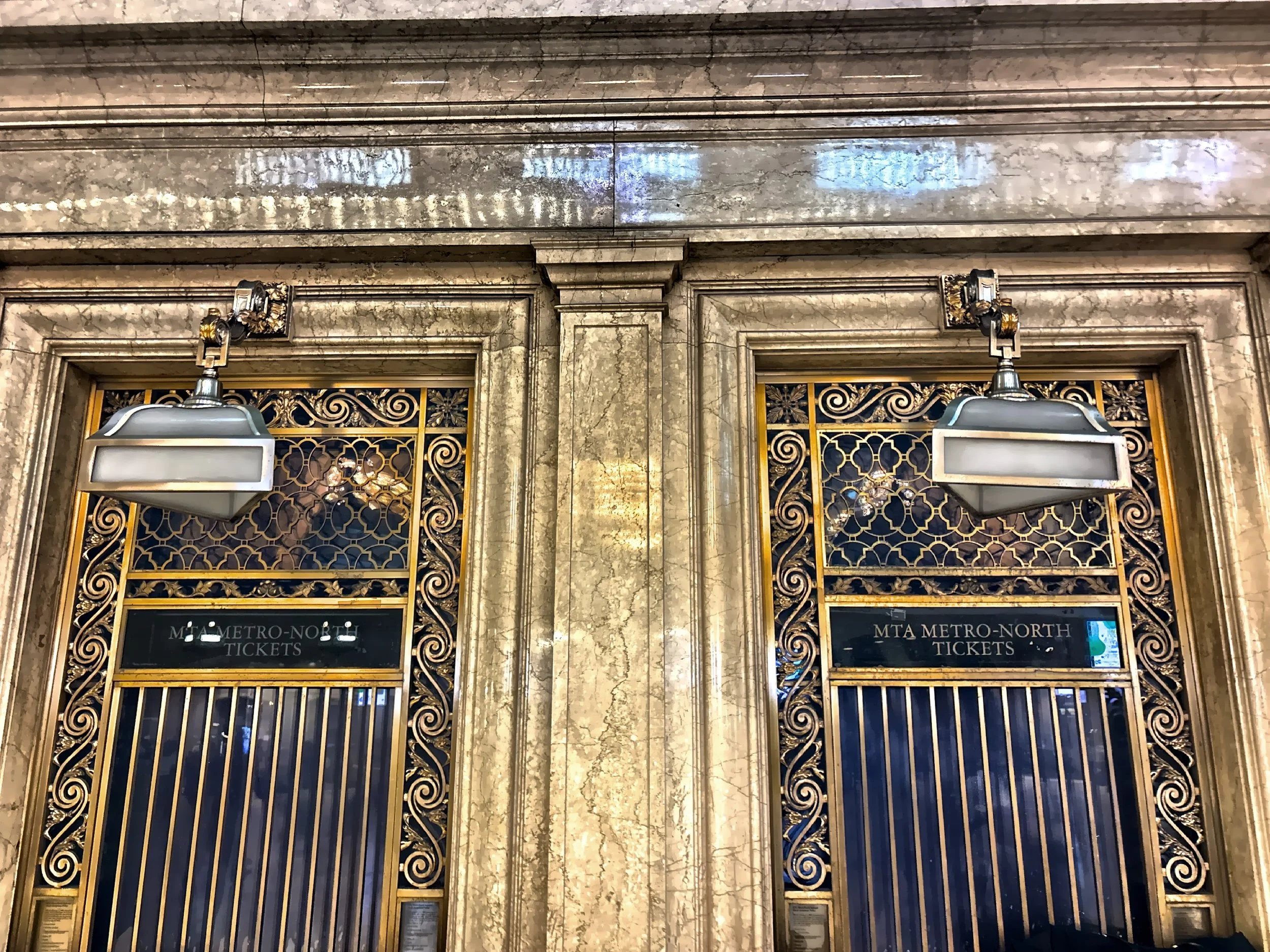  The ornate decorative metalwork and classic architecture of the historic ticket booths inside the Main Concourse. 