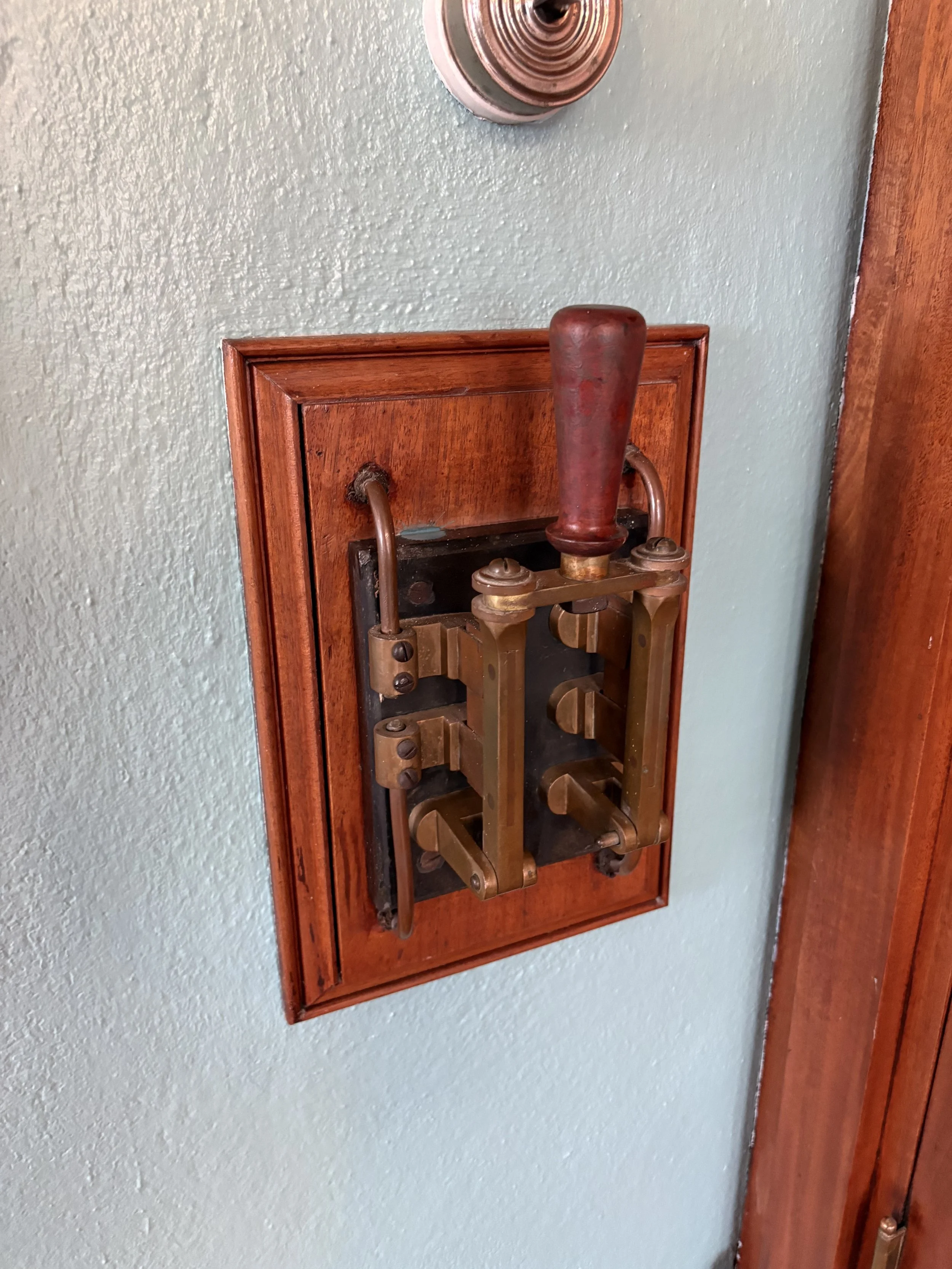  This antique slate and copper switch circuit breaker controlled the power coming into the house and was interestingly located in Sallie’s bedroom.  