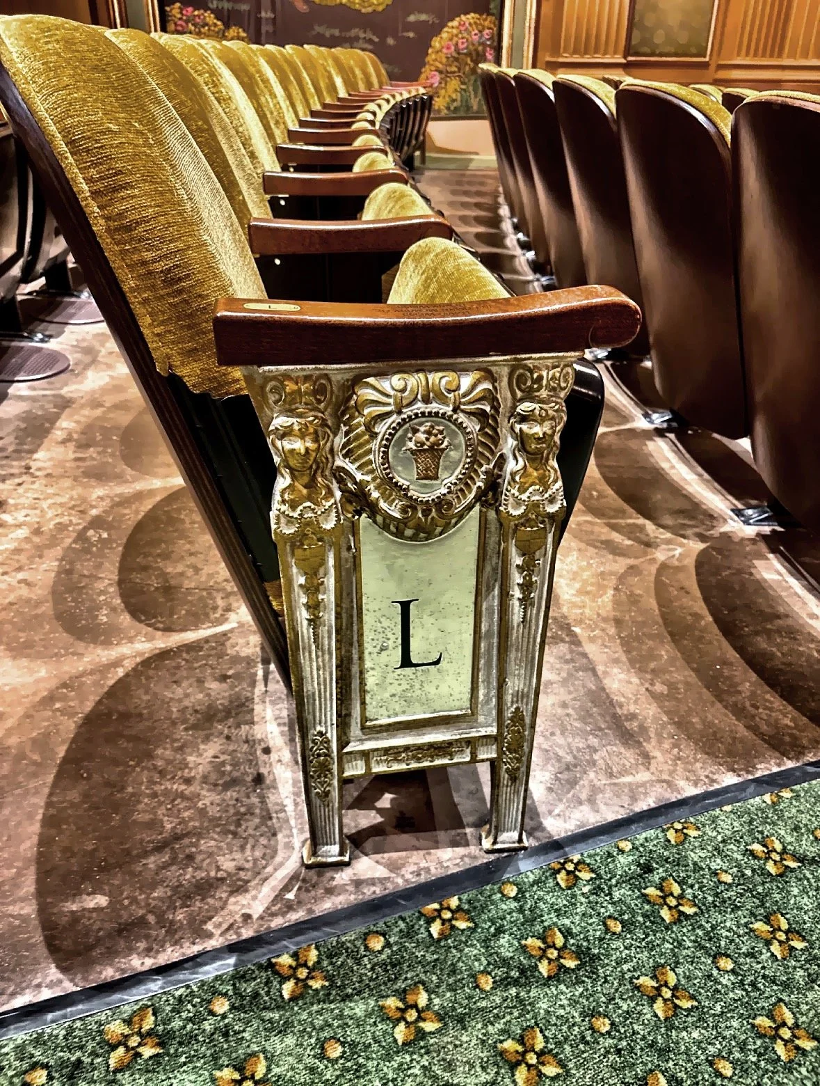  Even the smallest details inside the theater reflected its craftsmanship and historic charm. The heavy cast-iron aisle end caps, manufactured by the Heywood-Wakefield Company, showcased the quality and durability that defined many of America’s grand