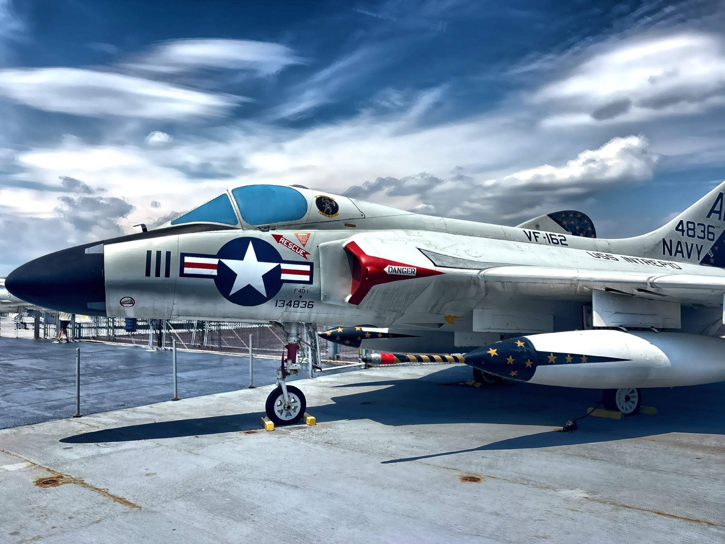  The deck is lined with aircraft from different eras, and standing among them while overlooking the Manhattan skyline. 