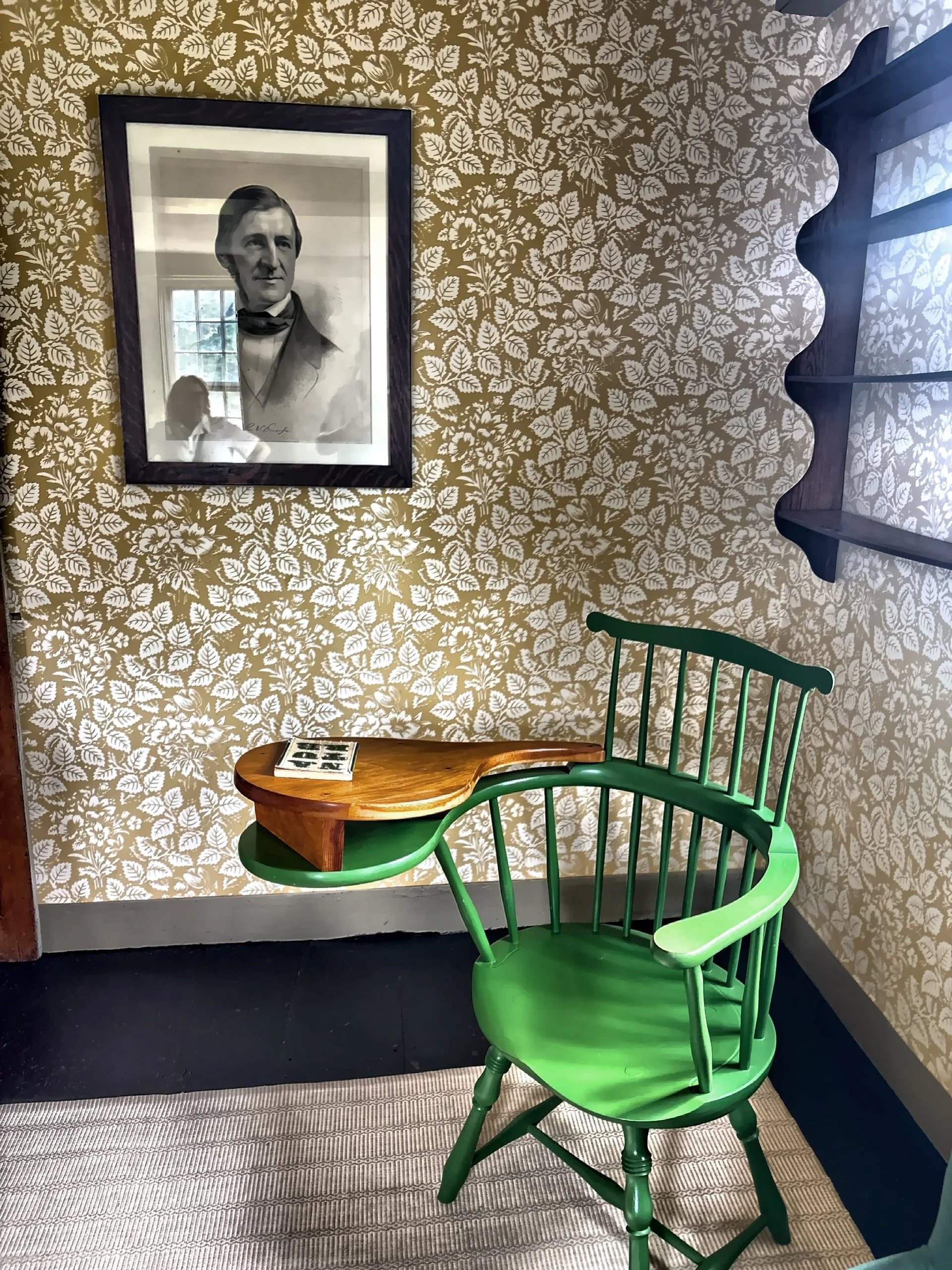  The vibrant greet replica of Ralph Waldo Emerson’s writing chair with wooden paddle surface for writing. 