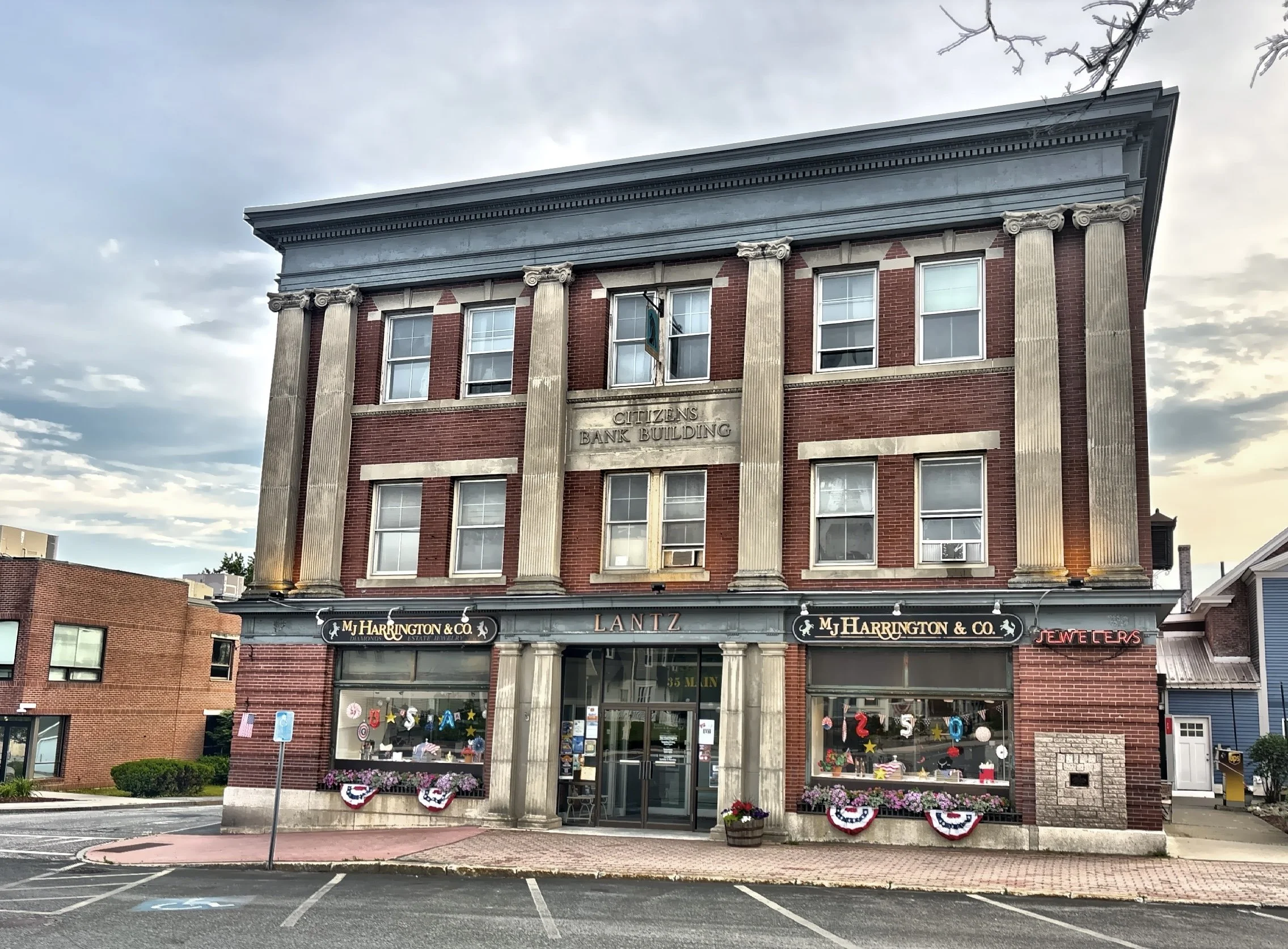  Large storefront windows at street level with offices, meeting halls, or apartments above. 