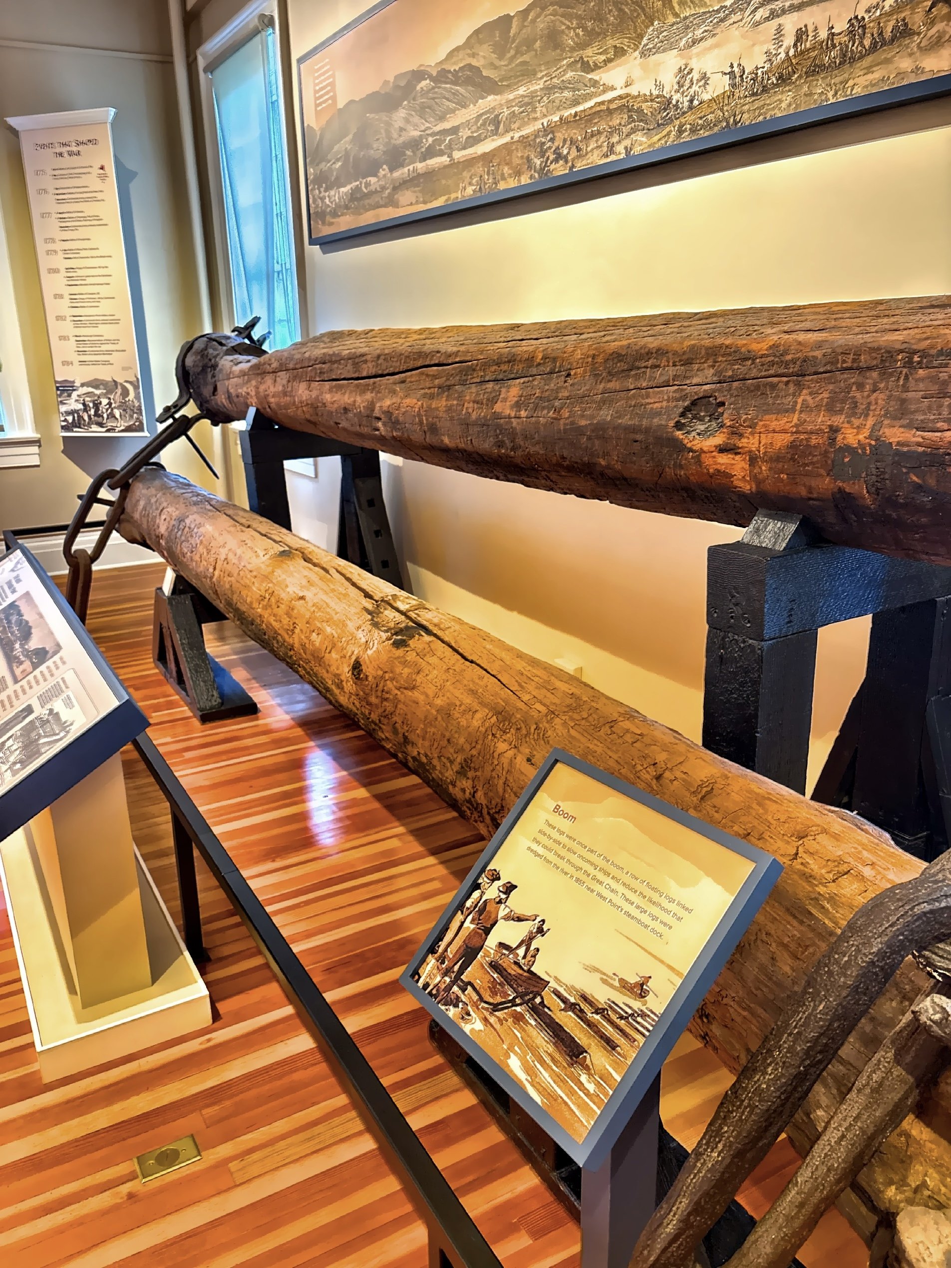  One of the most striking displays is a recreation of the Revolutionary War-era defenses that once stretched across the Hudson River. Massive timber logs were linked together and paired with the enormous iron Great Chain, creating a floating barrier 