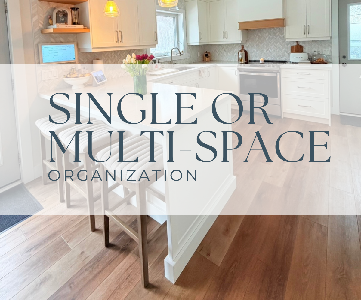 Bright kitchen with white cabinets, a kitchen island with seating, wooden flooring, a window above the sink, and a vase of flowers on the counter, with overlay text reading 'Single or Multi- Space Organization'.