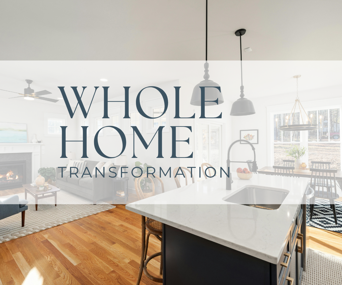 Bright open-concept living room and kitchen with hardwood floors, modern white cabinetry, pendant lighting, and large windows, showcasing a home interior renovation.