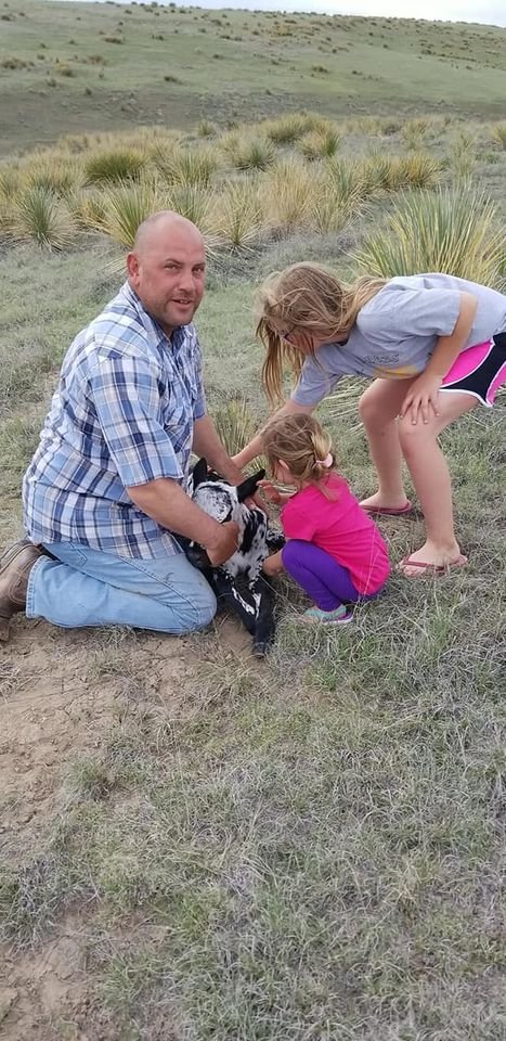Matt and the girls with baby calf.jpg