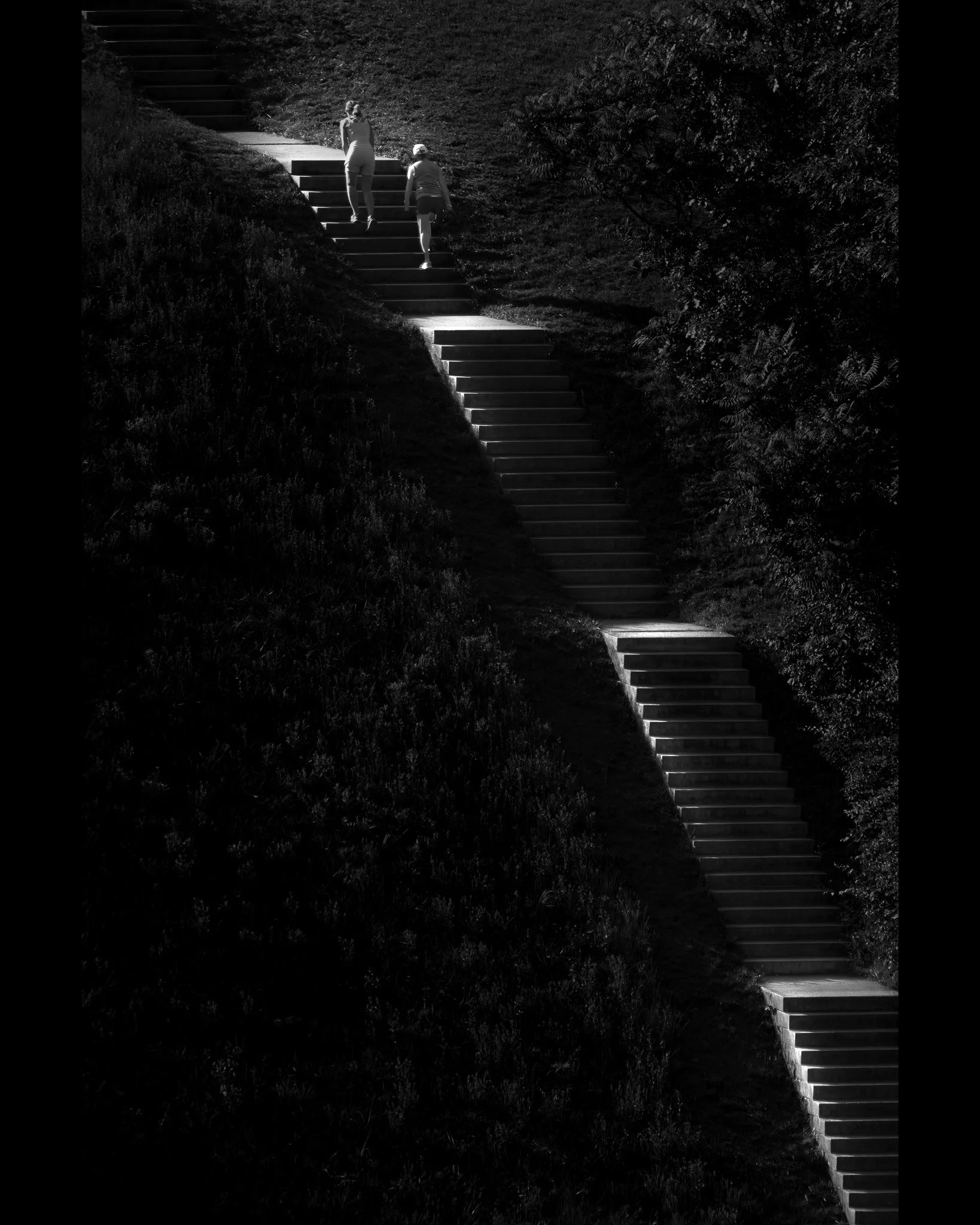 Social Climbers
Bored on the StairMaster at the gym? These two walkers got their workout climbing a long set of stairs heading to the top of the Wachusett Reservoir Dam in Clinton, MA.  Taken later in the day, the side light was hitting just each lan