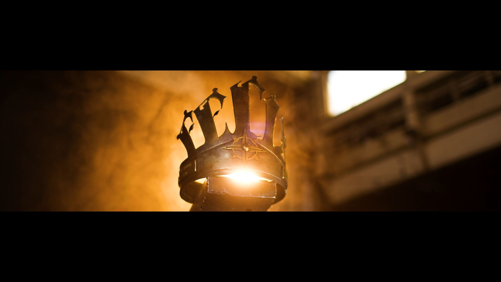 Hero shot of the finished crown -- backlit with haze, the light peaked through the anvil and the crown. Using the window and natural light in the top right to provide more life to the scene and guide the eyes, while letting the frame drop off to the