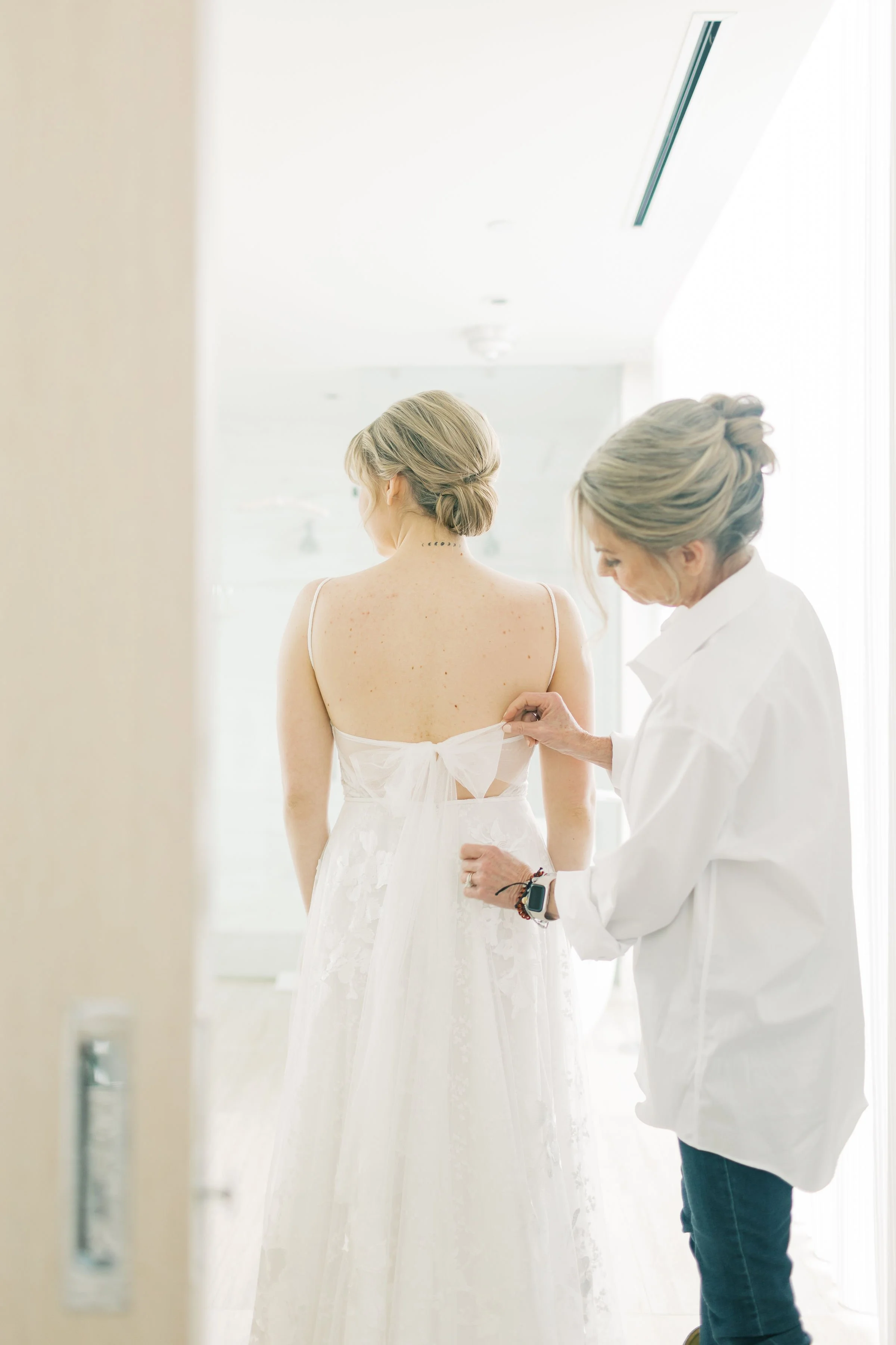 Mother helps Bride put wedding dress on | Moch Snyder, Fort Worth Wedding Photographer