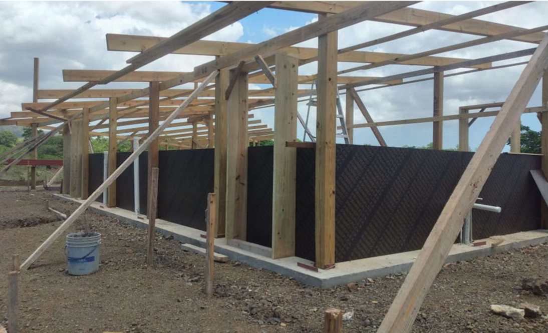 The formwork for the Rammed Earth Walls (REW) fastened to the wood frame.