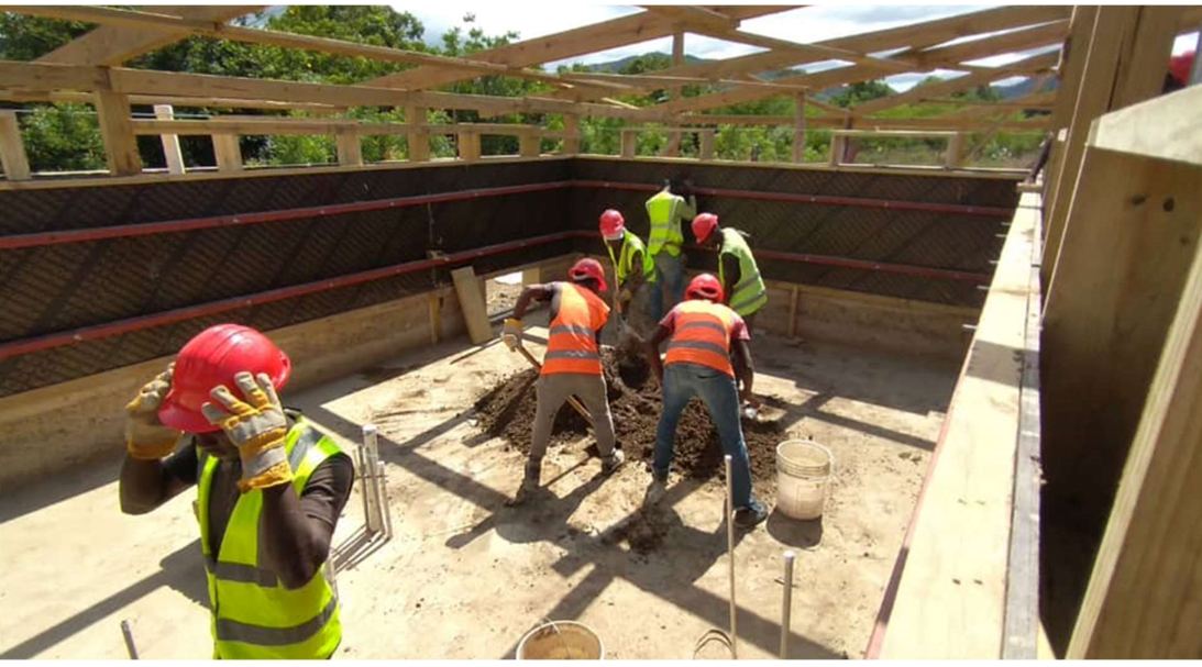 The material for the walls being mixed with sand, small gravel, cement and water. (August 2022)