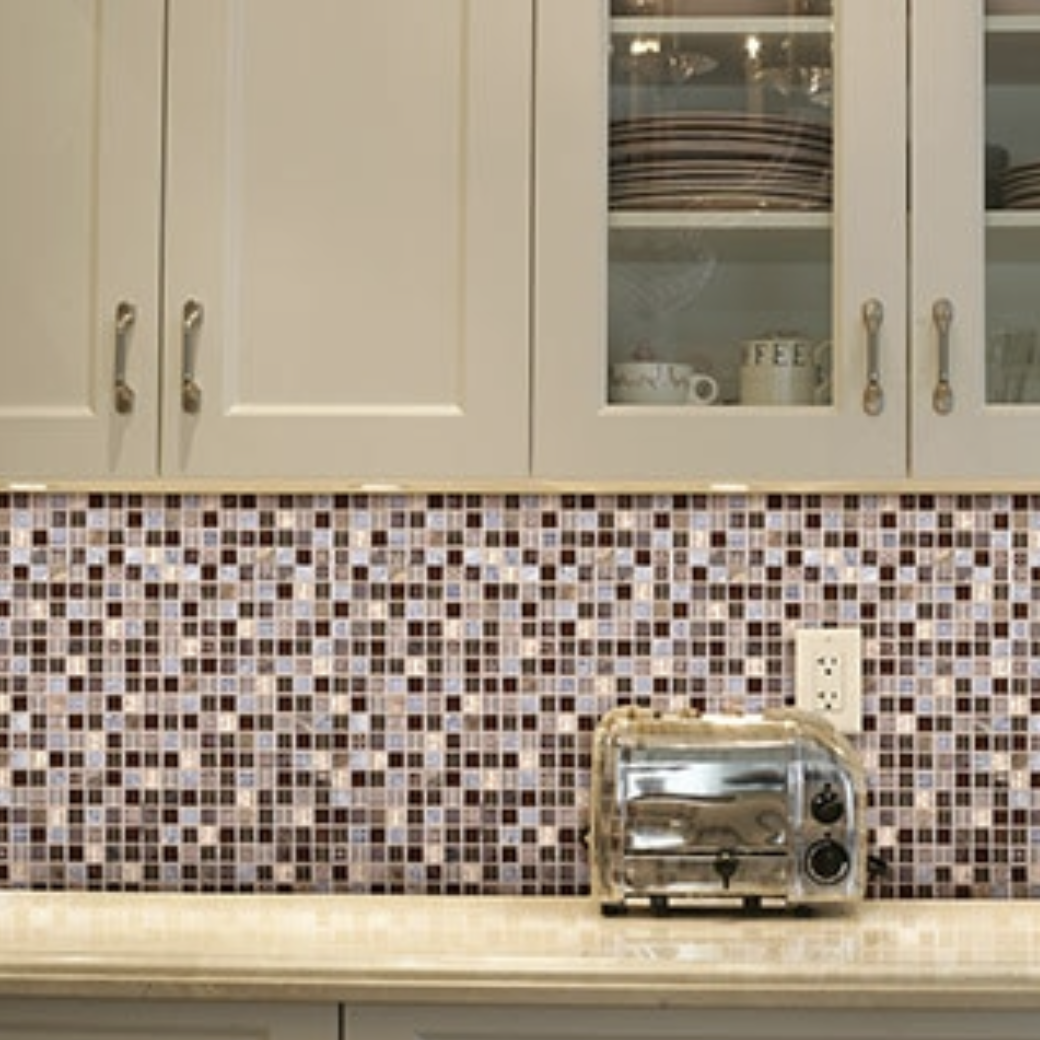 If you need to add interest, consider going with a multi-colored backsplash tile. Mosaic tile innately adds dimension; the addition of multiple colors even more so. Rather than trying to come up with a color scheme from scratch, base the whole design